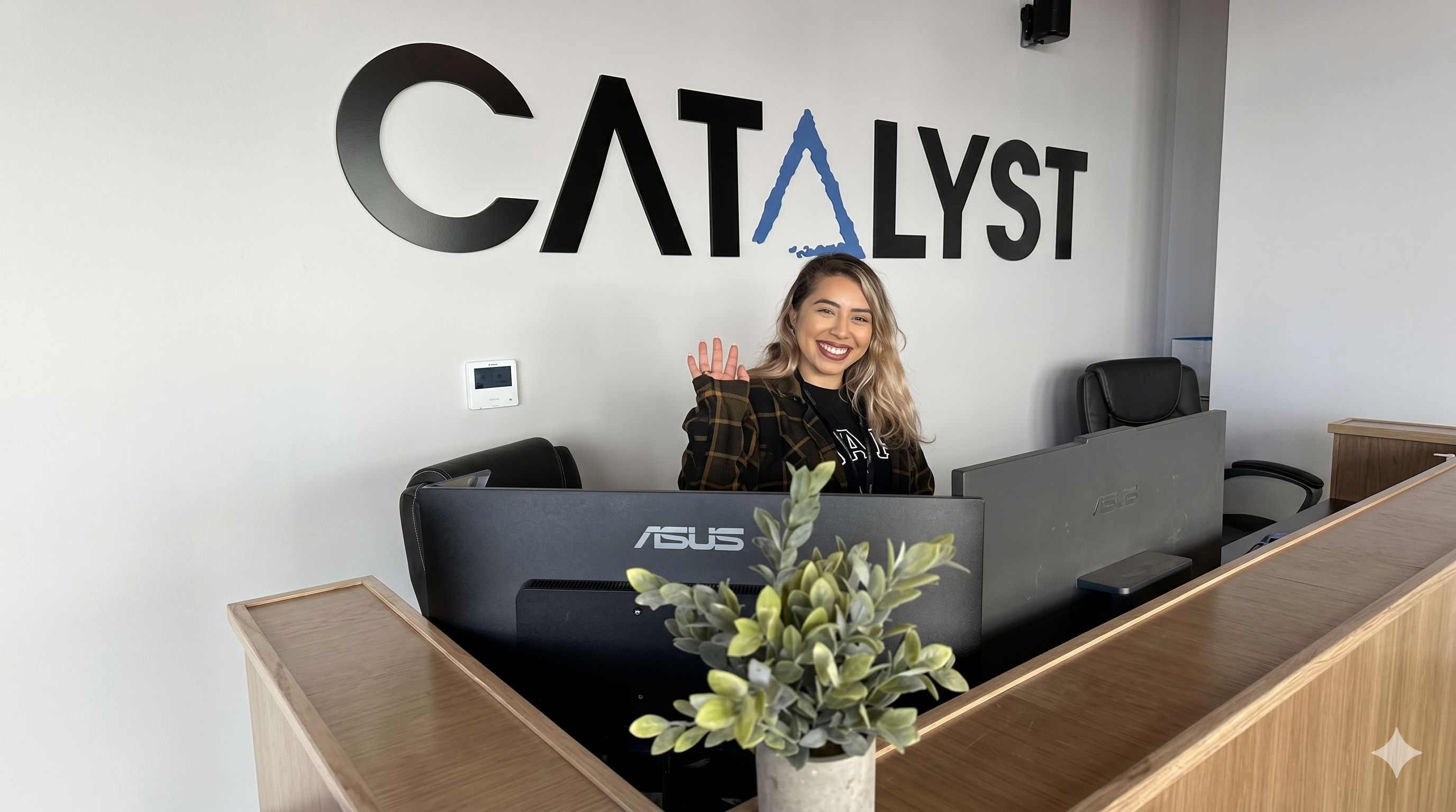 A friendly staff member greeting a customer at the front desk of Catalyst Cannabis dispensary in Antioch, California