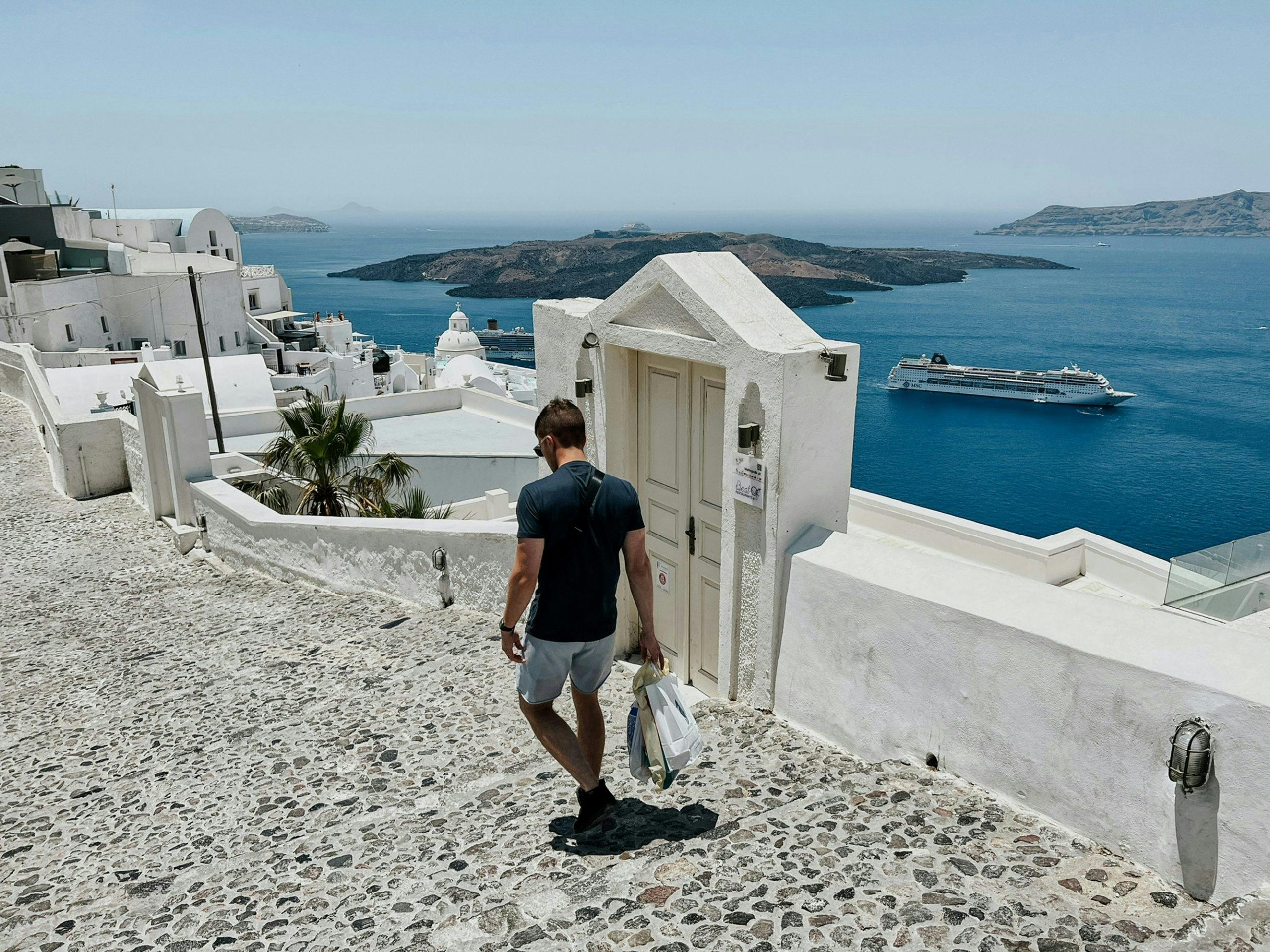 Picturesque alleyway in Santorini featuring classic Greek island architecture.