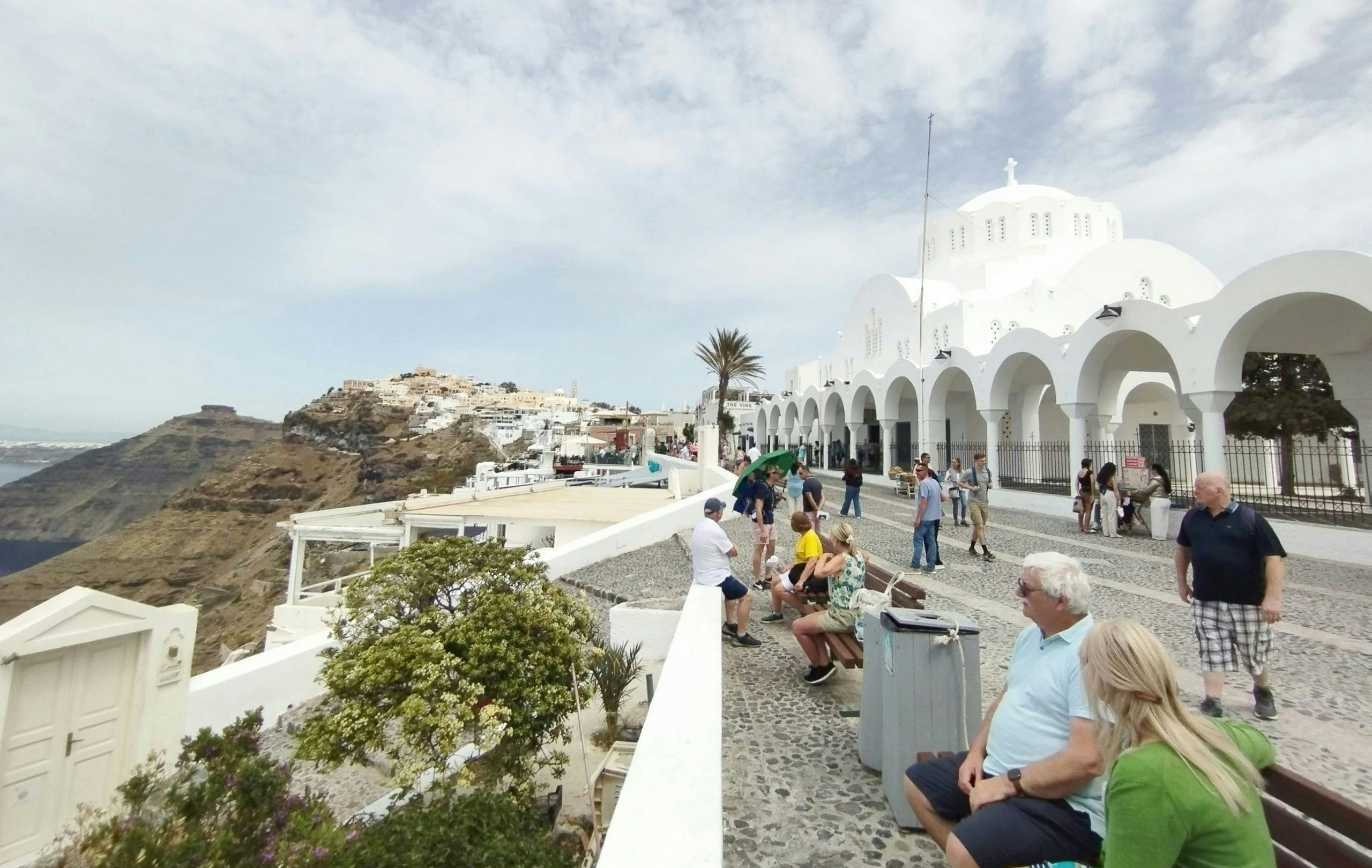 Visitors exploring the iconic whitewashed neighborhoods of Santorini