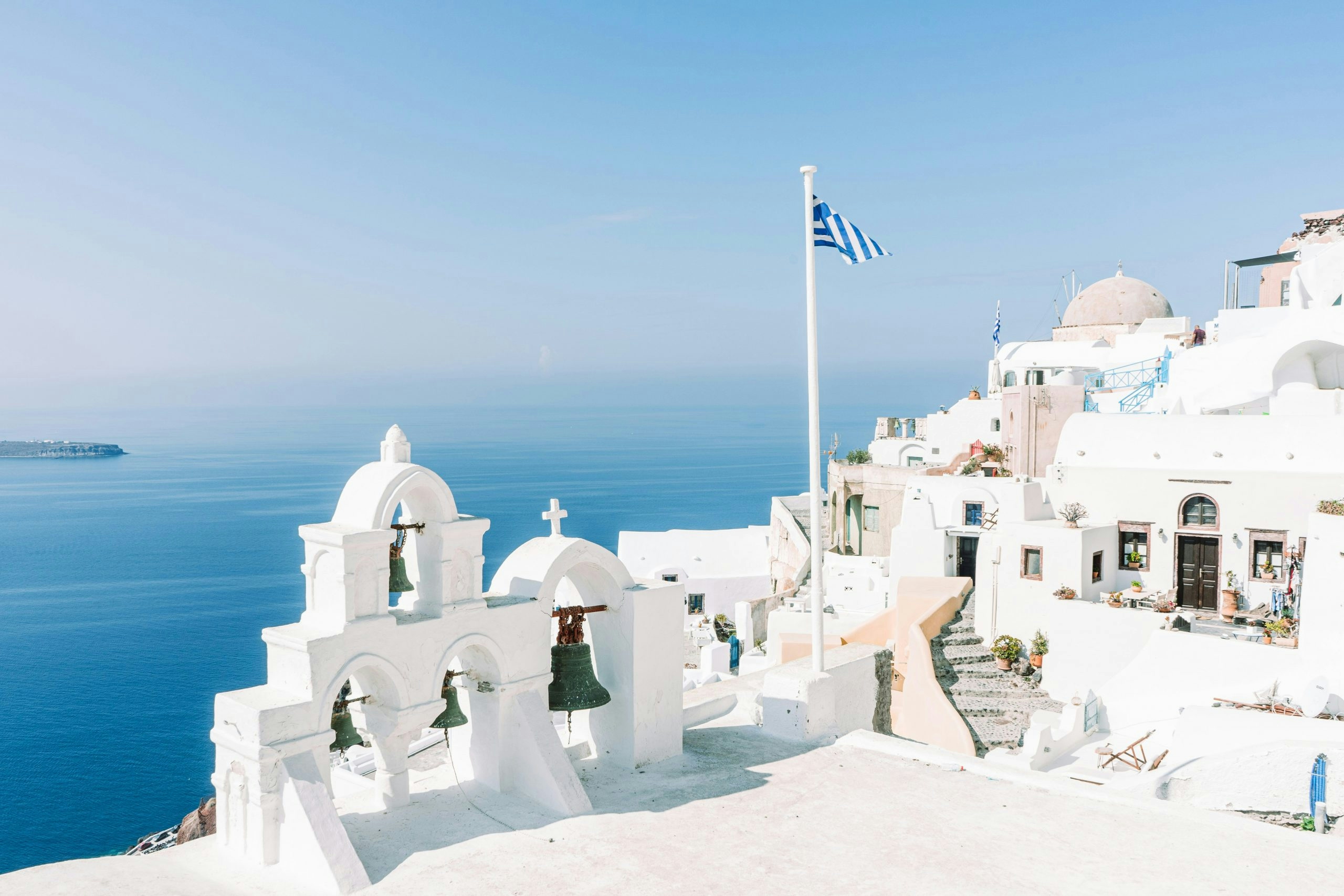 Iconic blue-domed church overlooking the Aegean Sea in Santorini, Greece