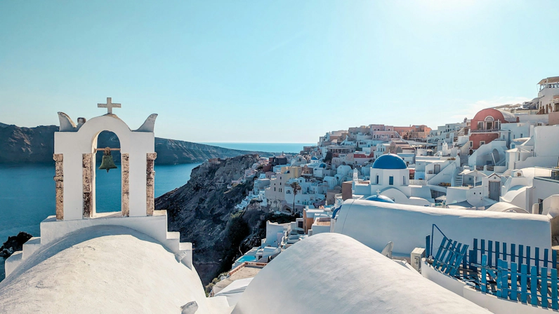 Drone view of Santorini's caldera and iconic cliffside architecture.