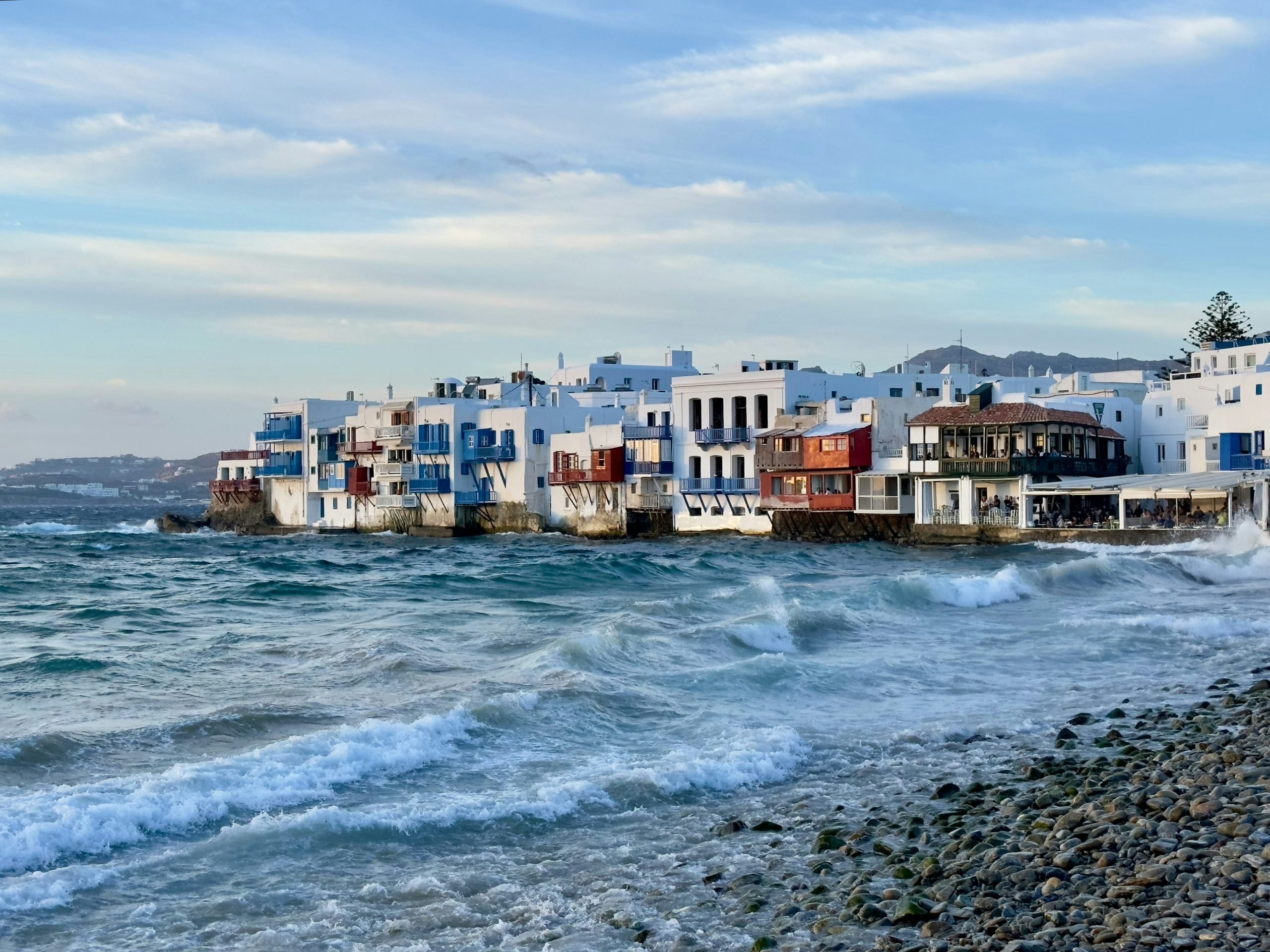 Panoramic view of Mykonos featuring whitewashed buildings and the Aegean Sea