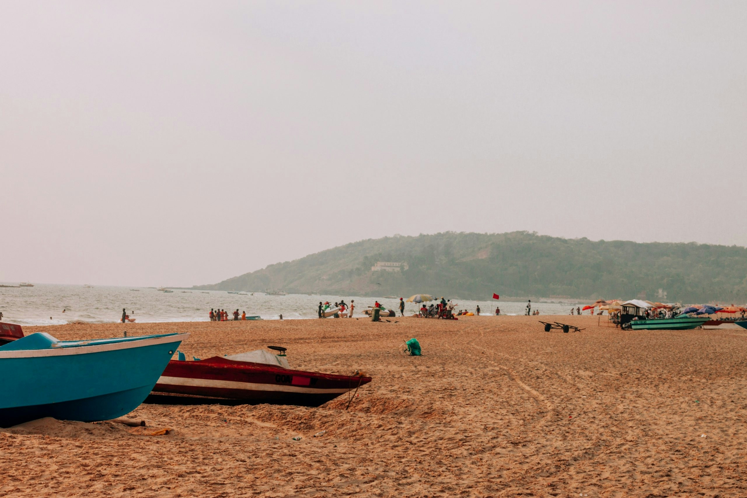 Travelers walking along a beach in Goa enjoying a relaxed tropical lifestyle