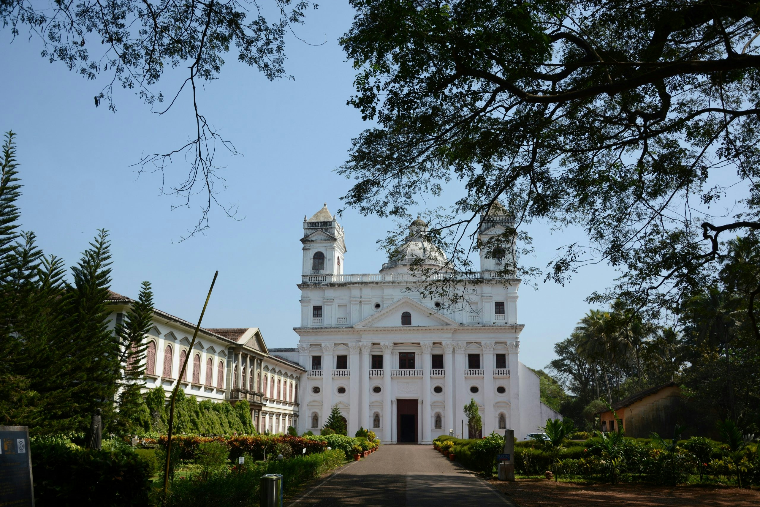 Old town street in Goa showcasing colonial architecture and tropical surroundings