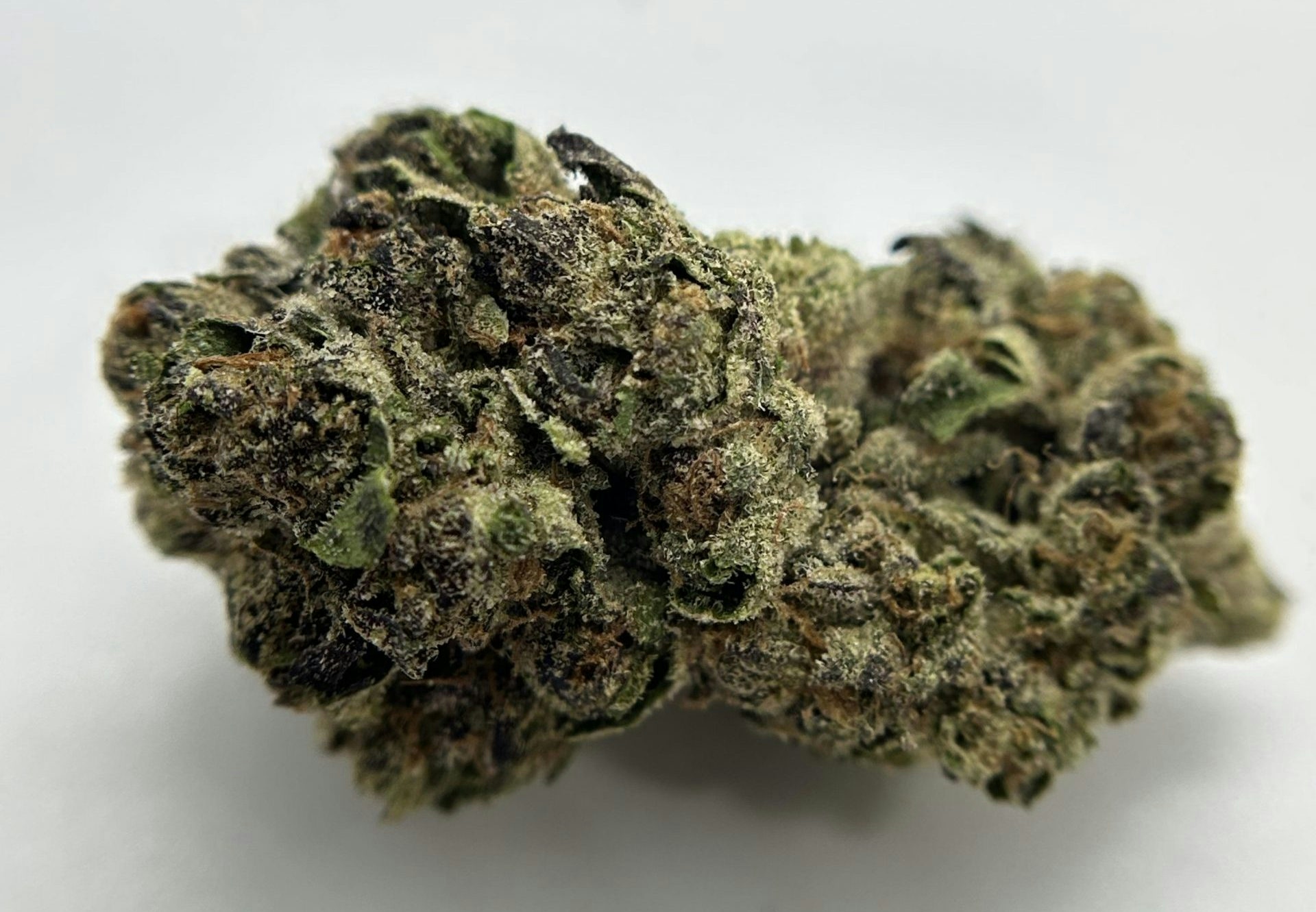Premium Pinnacle cannabis flower with dense bud structure and sparkling trichomes.