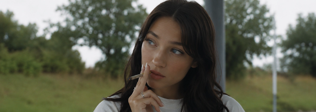 Woman smoking a hand-rolled cannabis joint