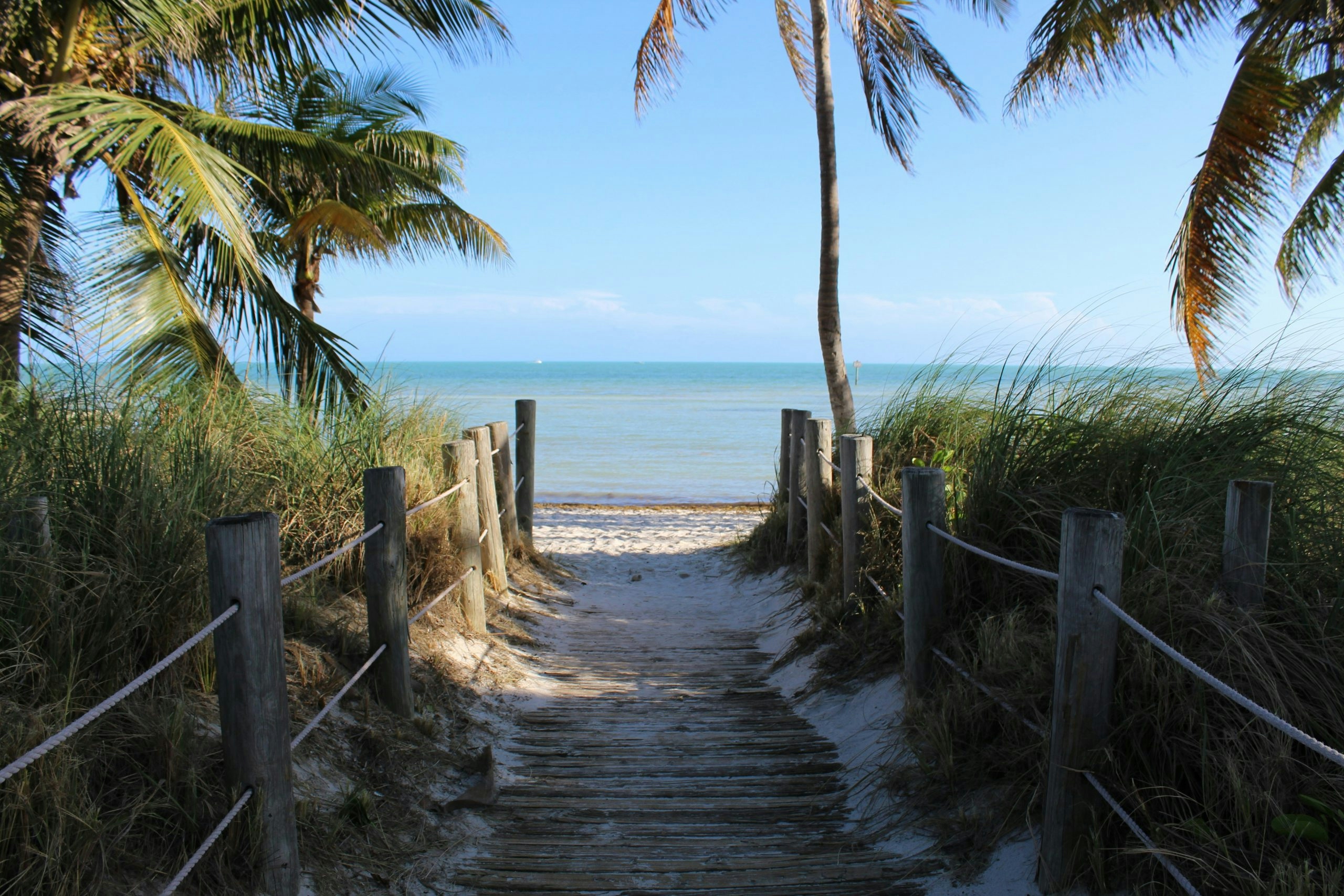 Tropical beach in Key West, Florida, with calm turquoise waters and a sunny coastline