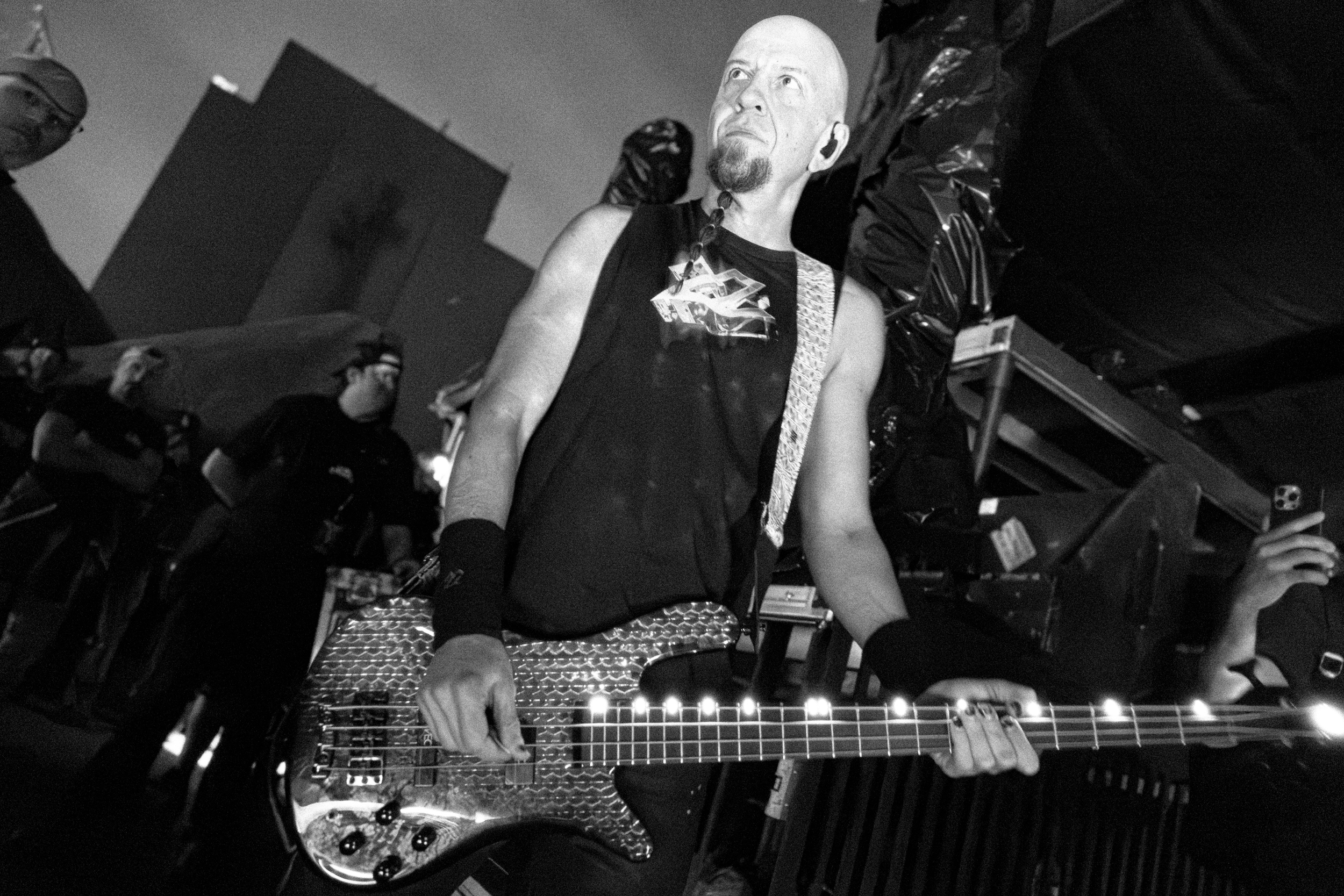 Shavo Odadjian performing live with dramatic lighting and a packed crowd