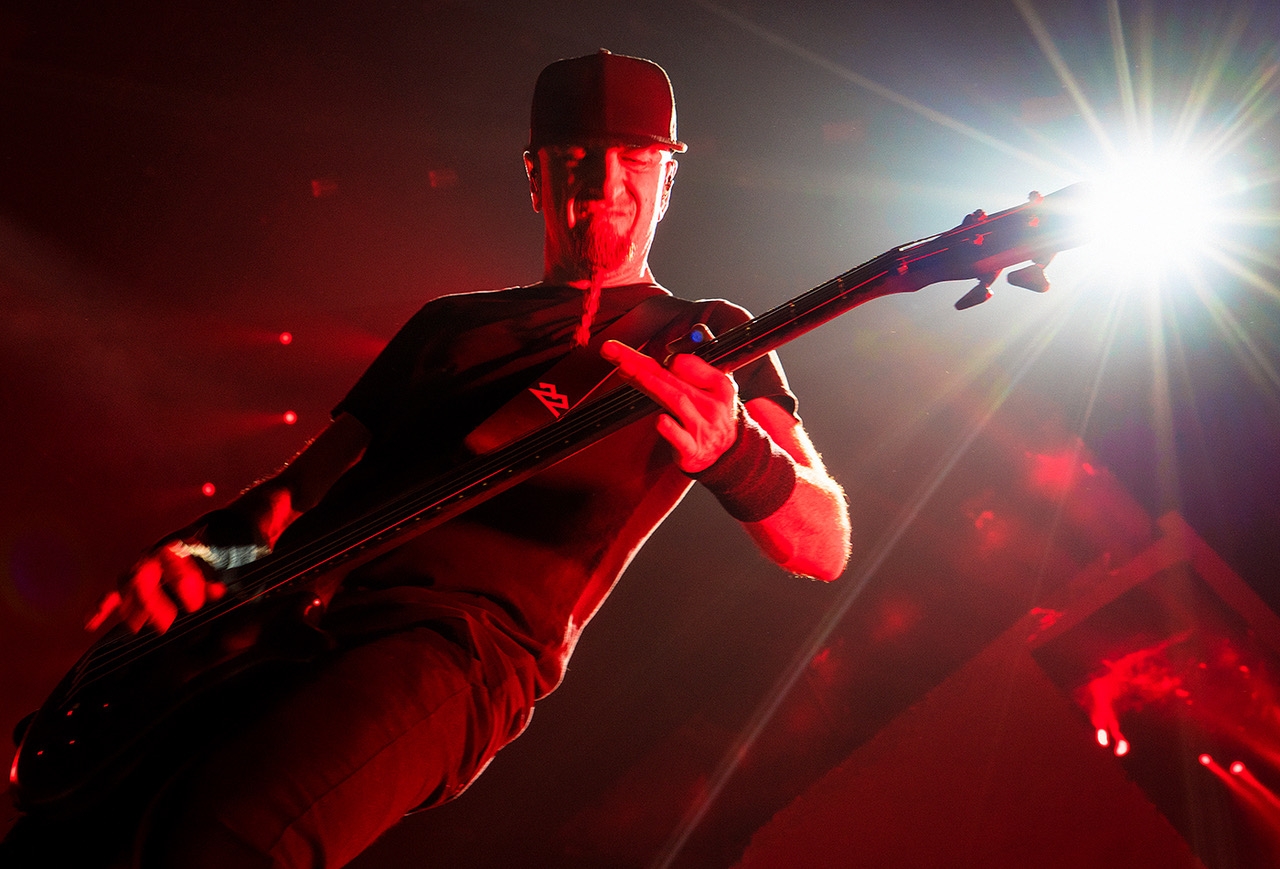 Close-up of Shavo Odadjian playing bass during a live show