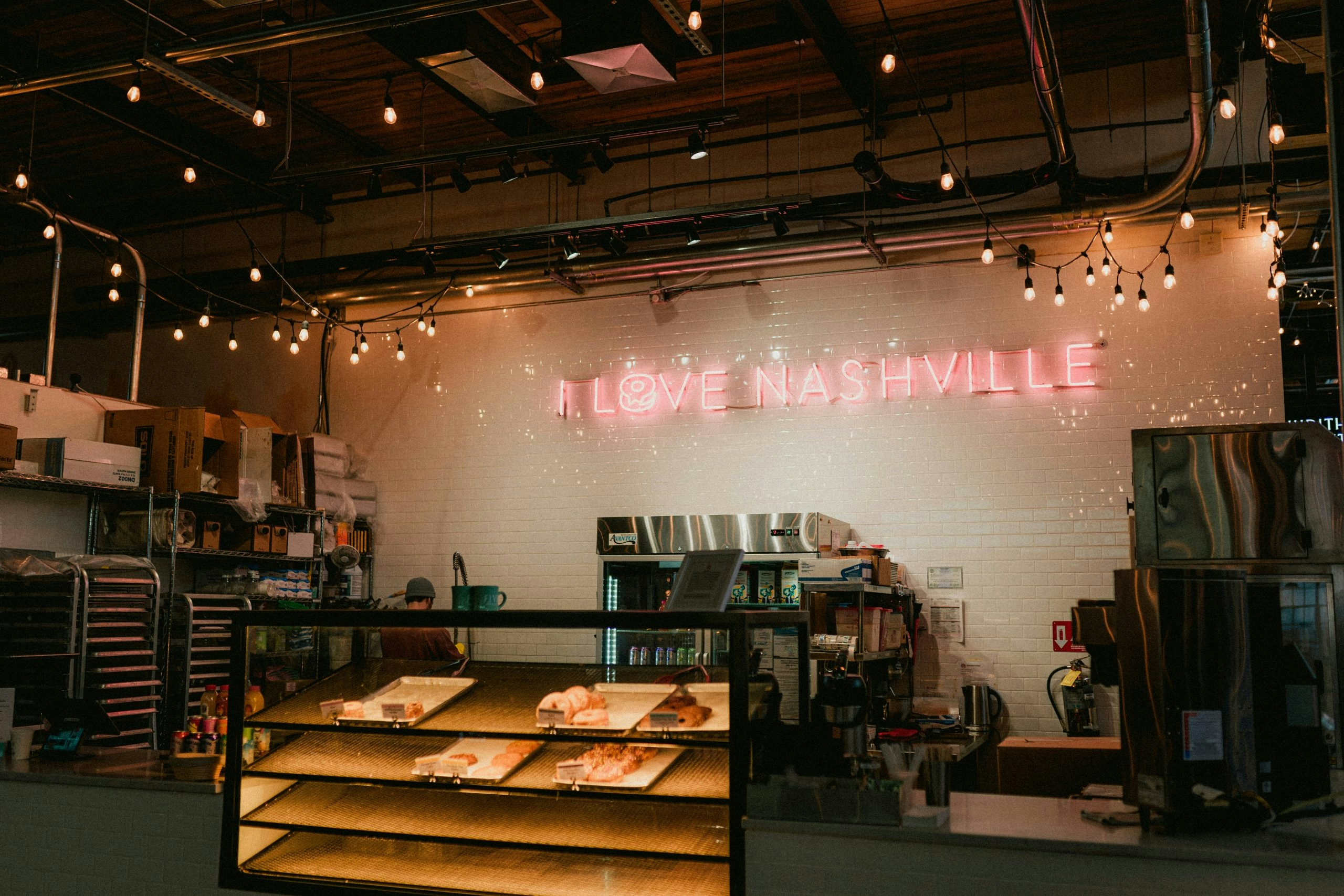 Neon 'I Love Nashville' sign illuminating the wall inside a private venue