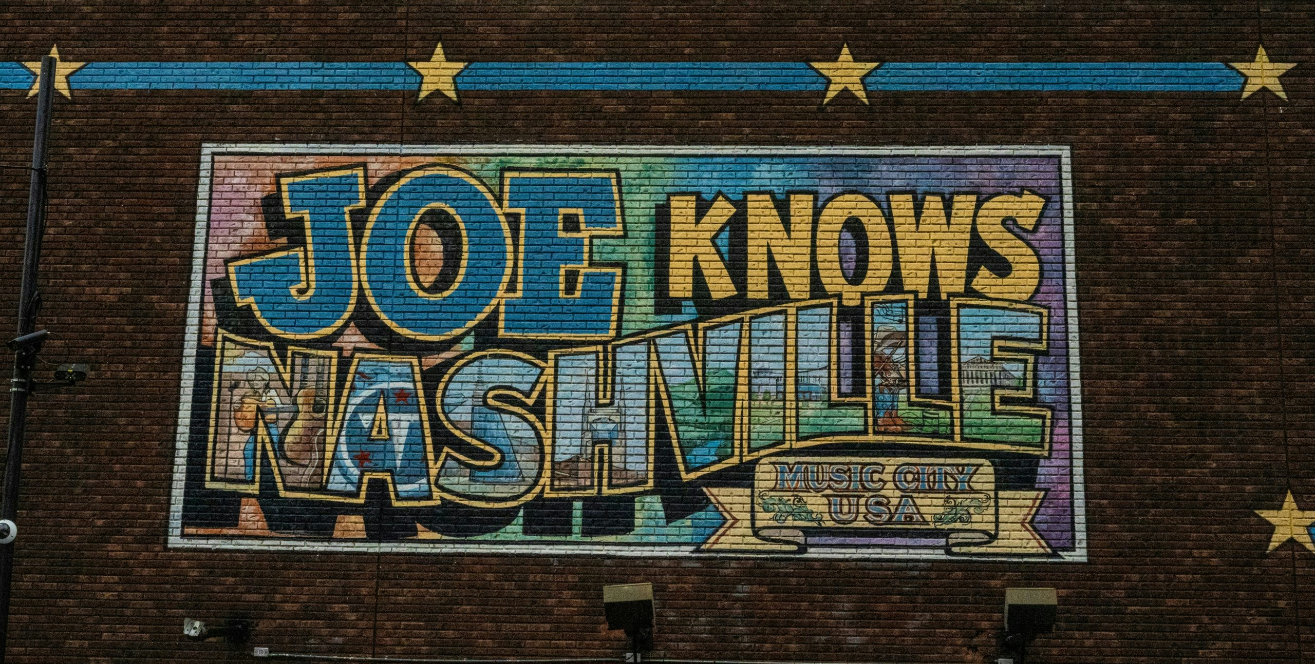 Street art mural with a large 'Nashville' sign in downtown Nashville