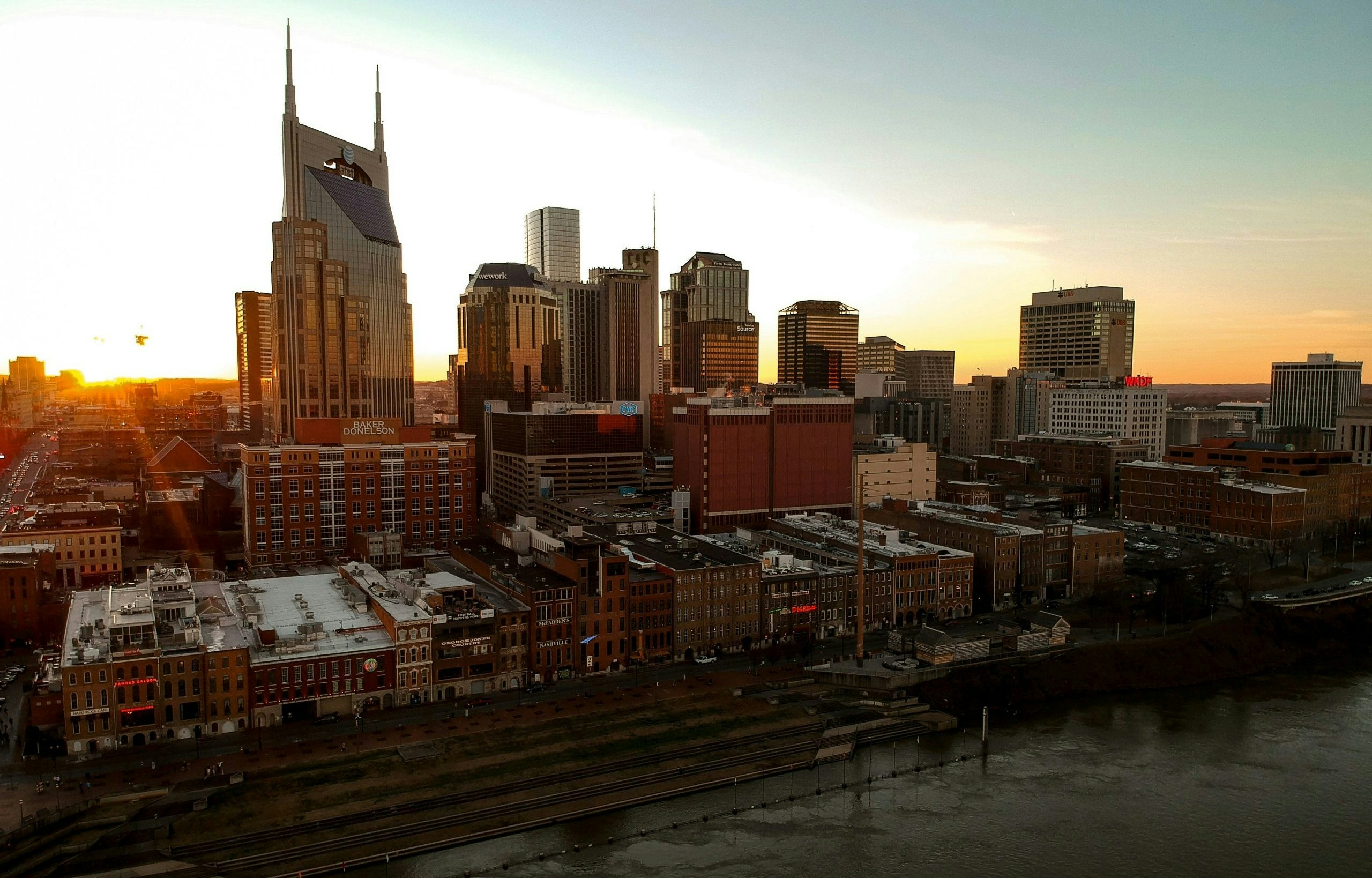 Downtown Nashville skyline featuring modern buildings and the Cumberland River.
