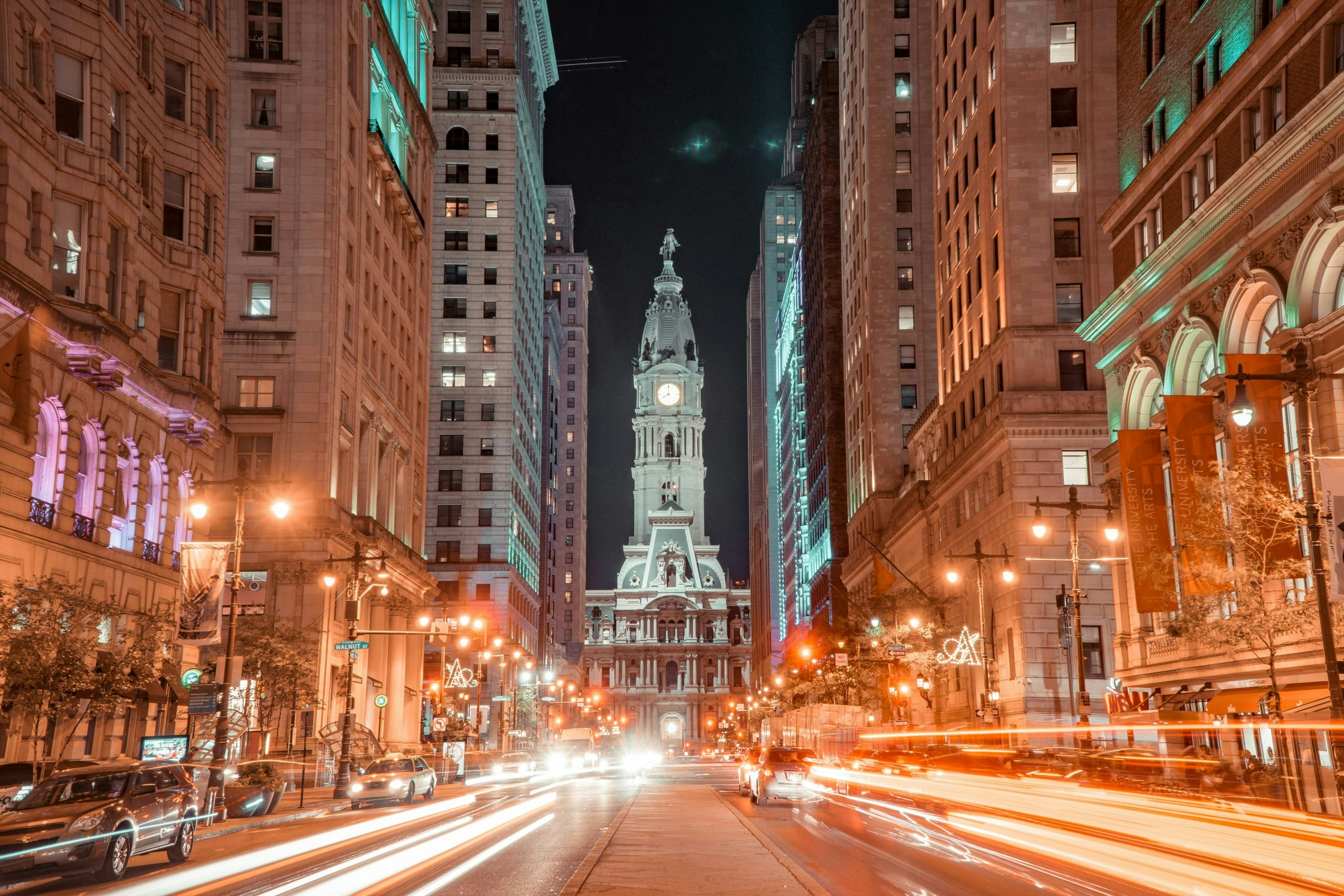 Busy street in downtown Philadelphia with pedestrians and historic architecture
