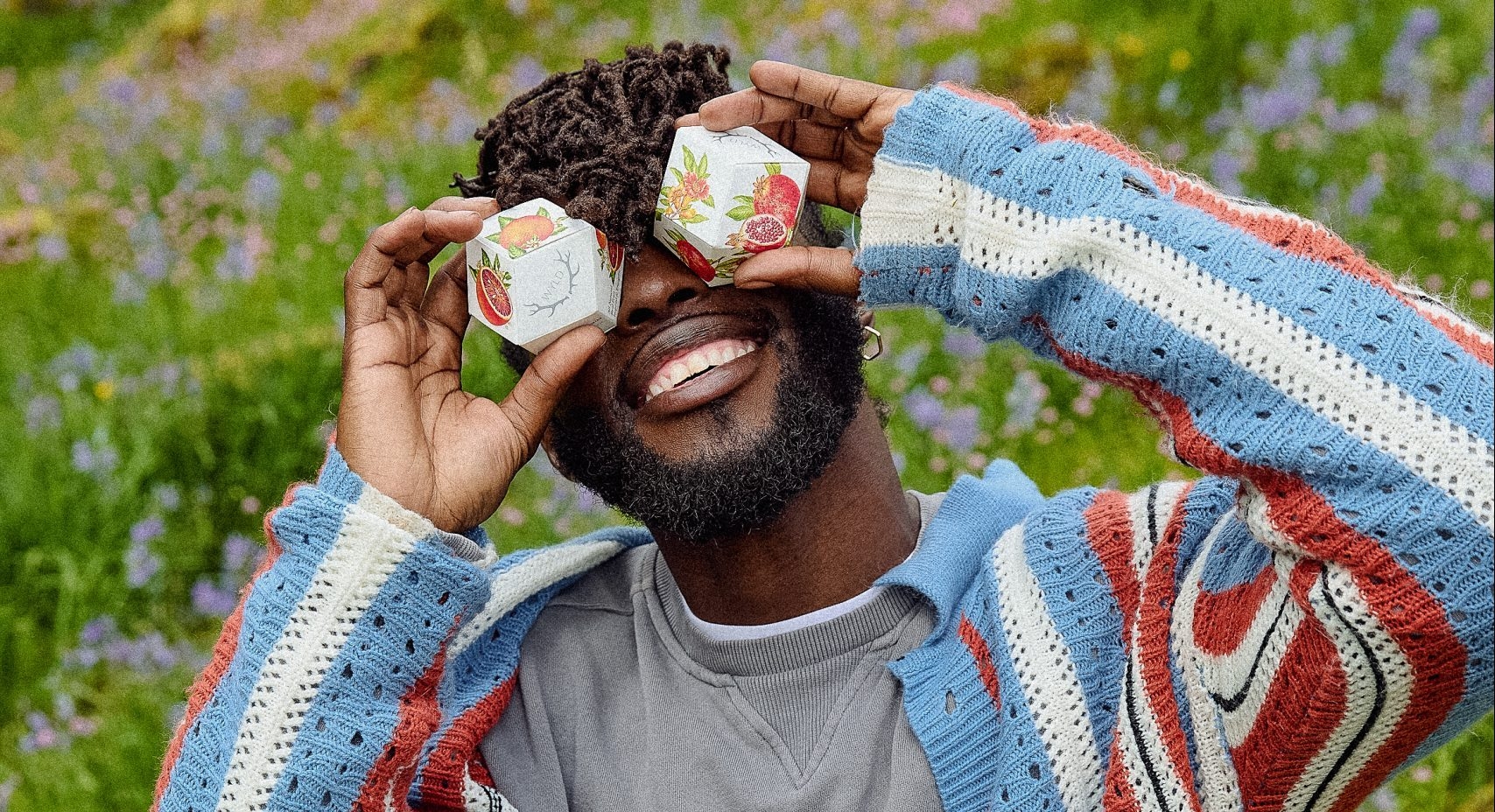 Man playfully holding Wyld Hemp Gummies package over his eyes