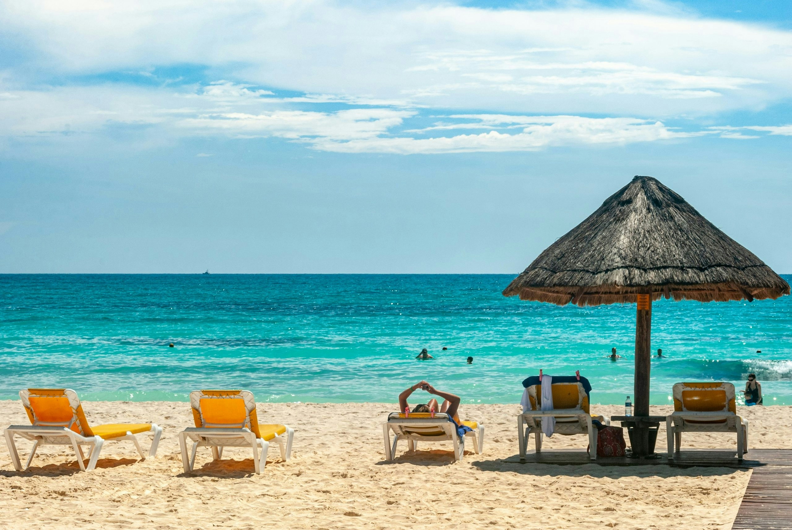 Turquoise beach waters in Cancun with white sand shoreline