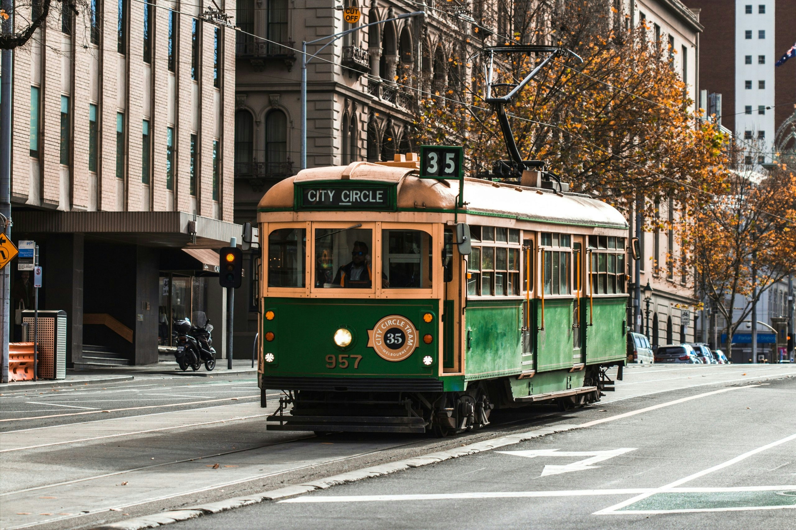 Classic tram passing historic buildings in central Melbourne
