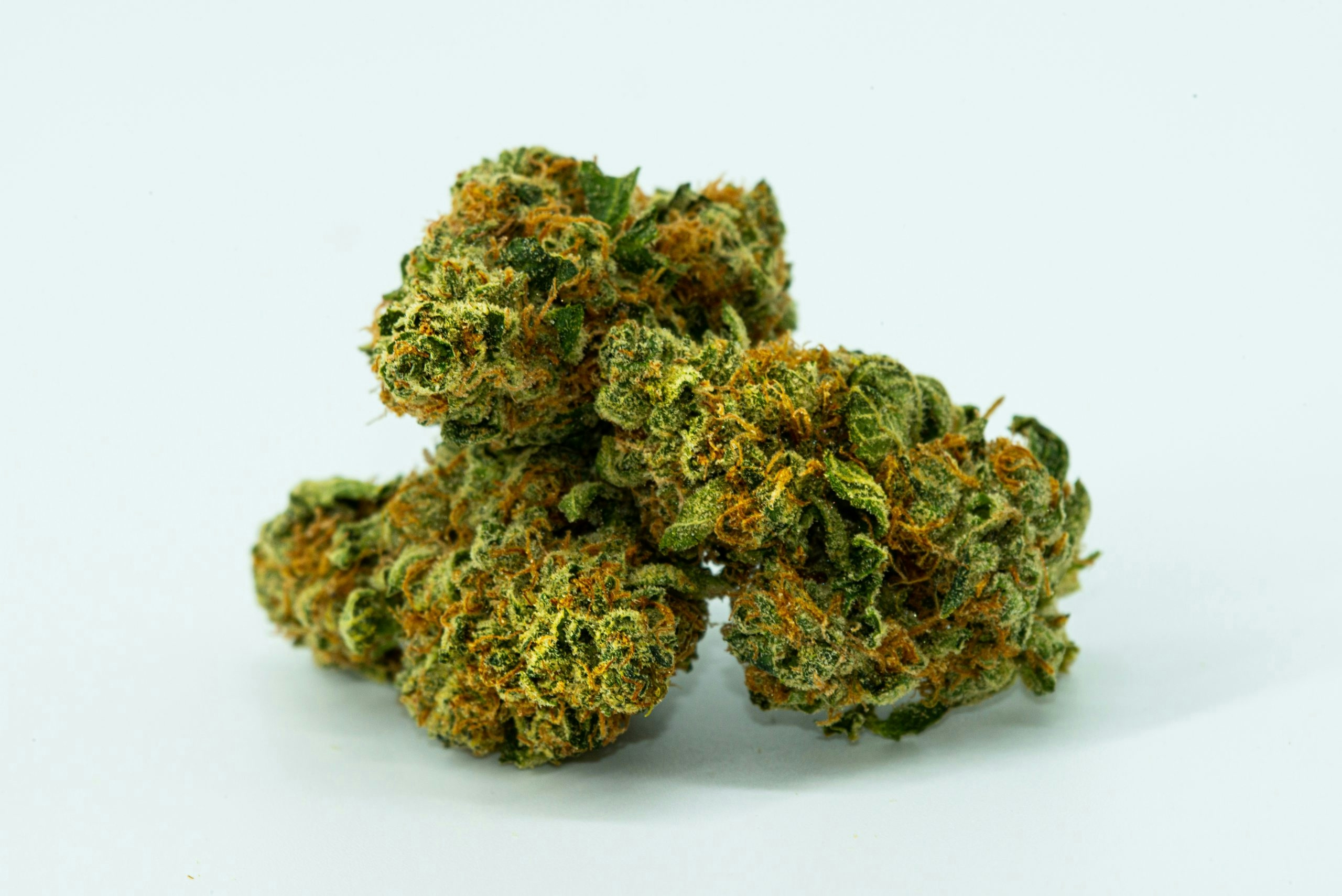 Collection of frosty cannabis buds spread across a flat surface