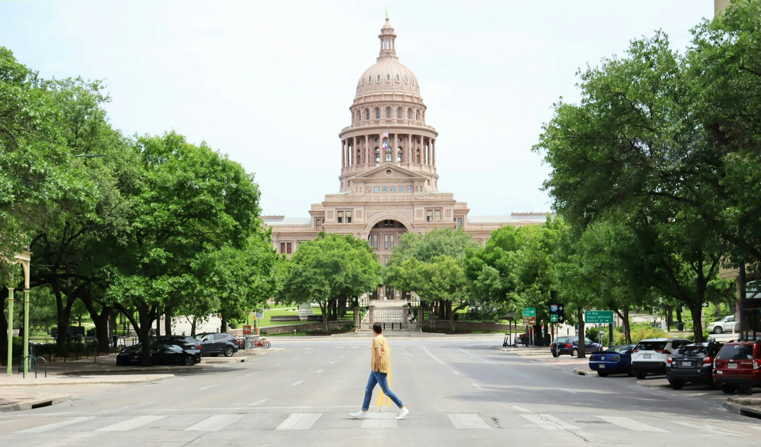 Pedestrian crossing the iconic Congress Avenue Bridge in Austin