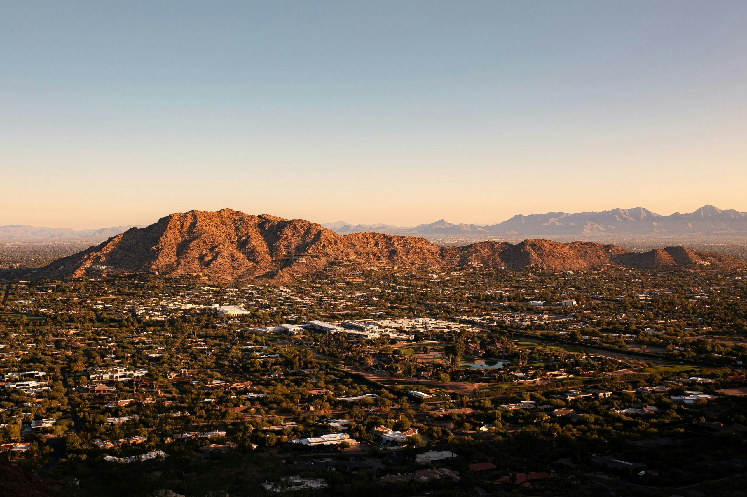 Aerial view of Phoenix featuring its modern skyline and surrounding mountains