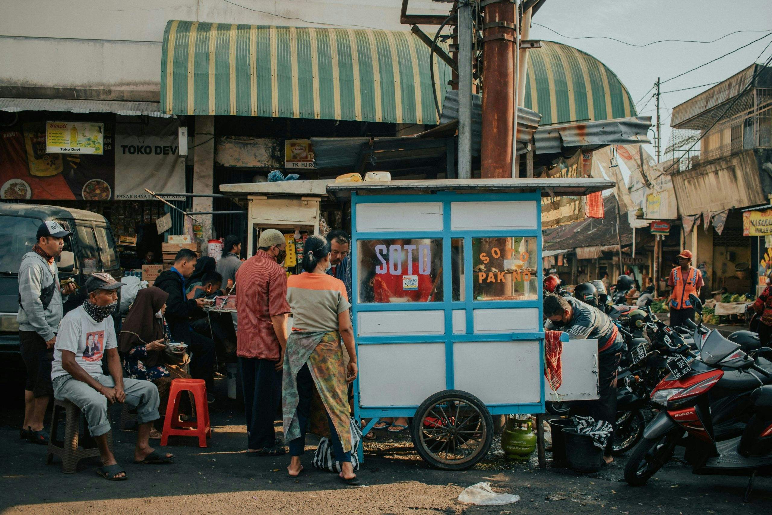Busy street in an Indonesian city with local shops and traffic