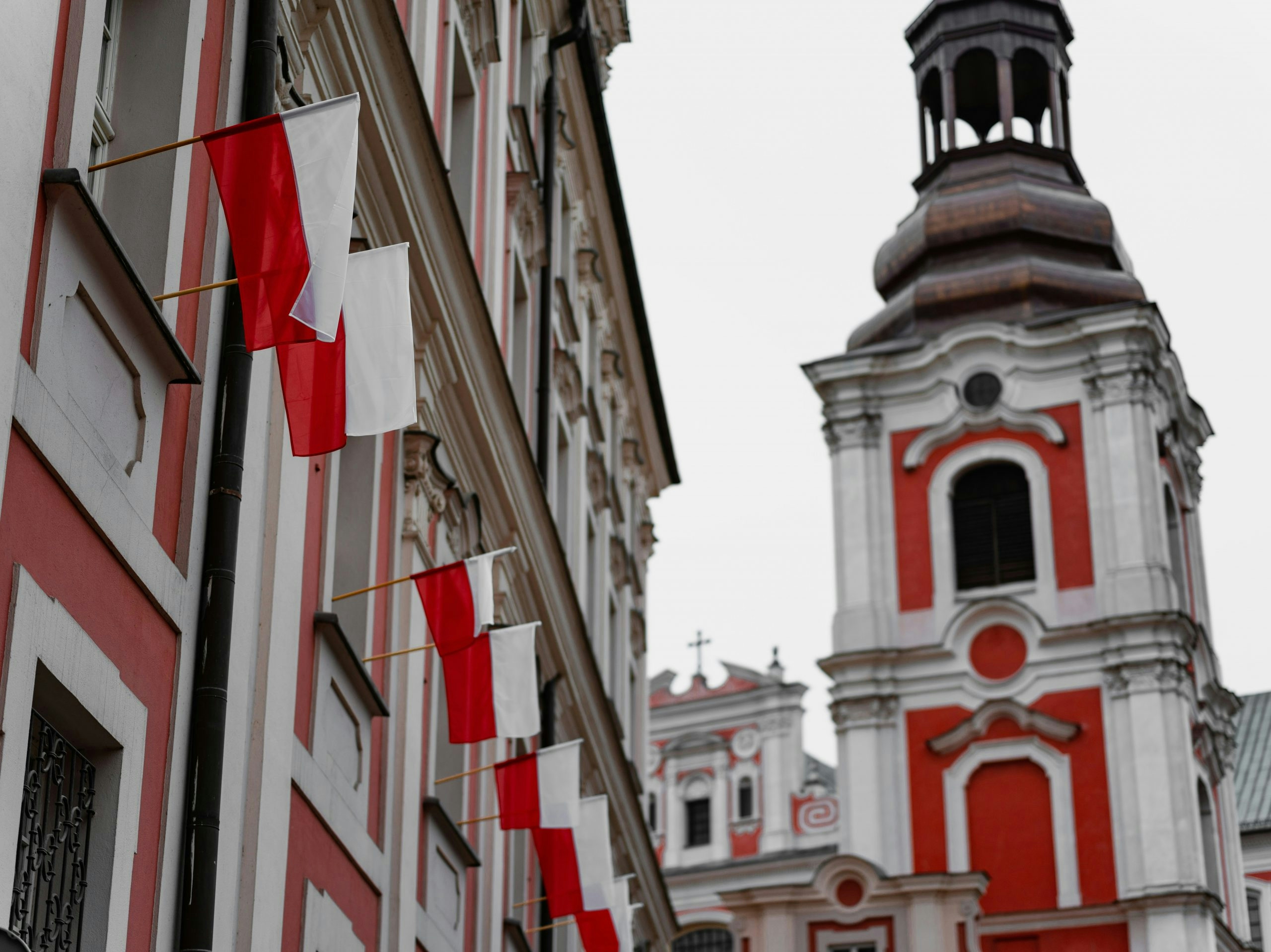 Red and white Polish flags flying outdoors