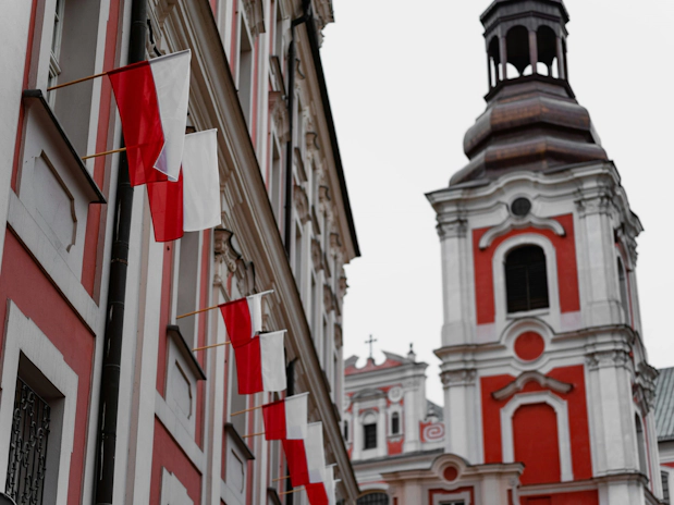Red and white Polish flags flying outdoors