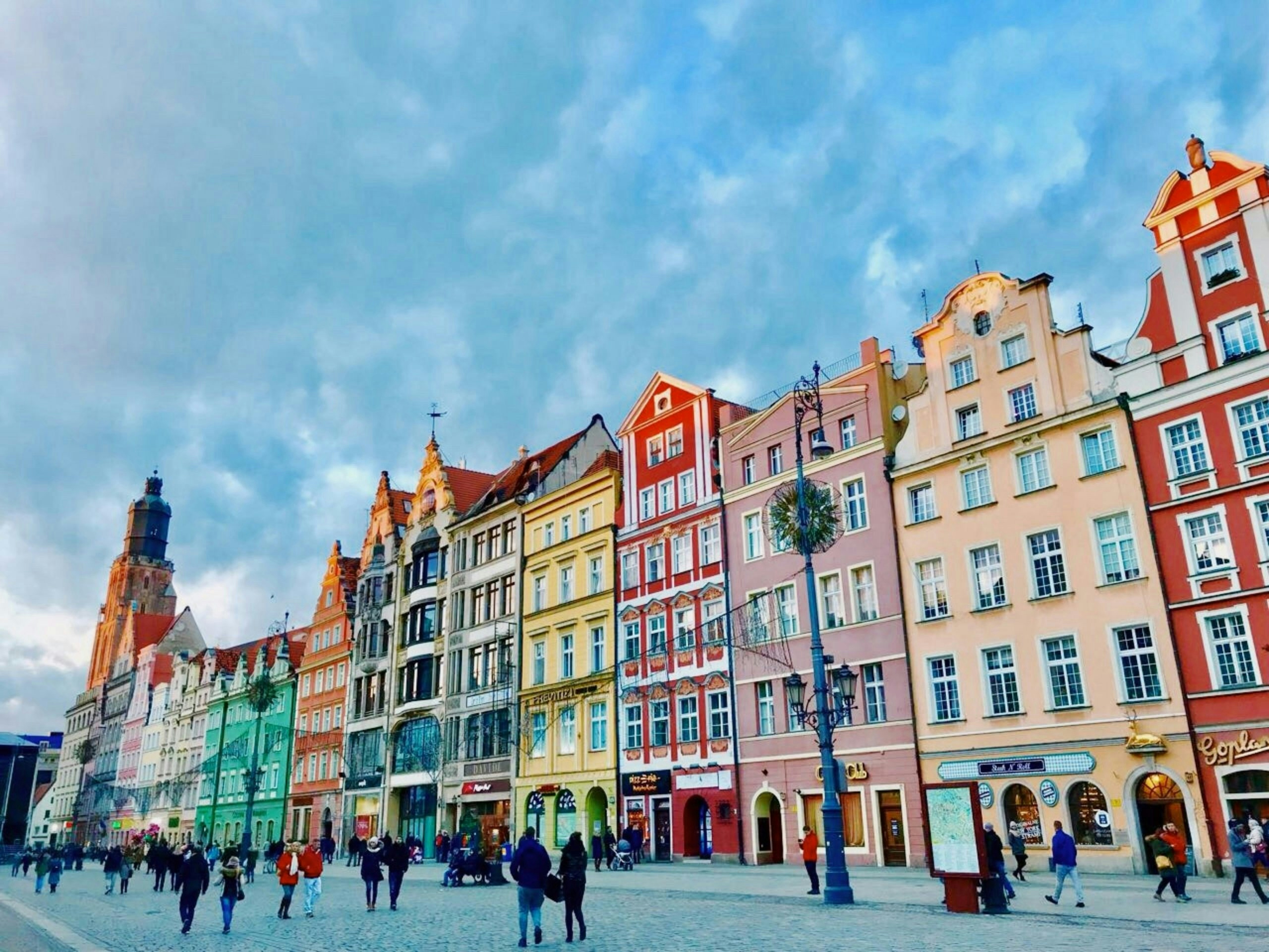Colorful historic buildings lining a cobblestone street in Poland