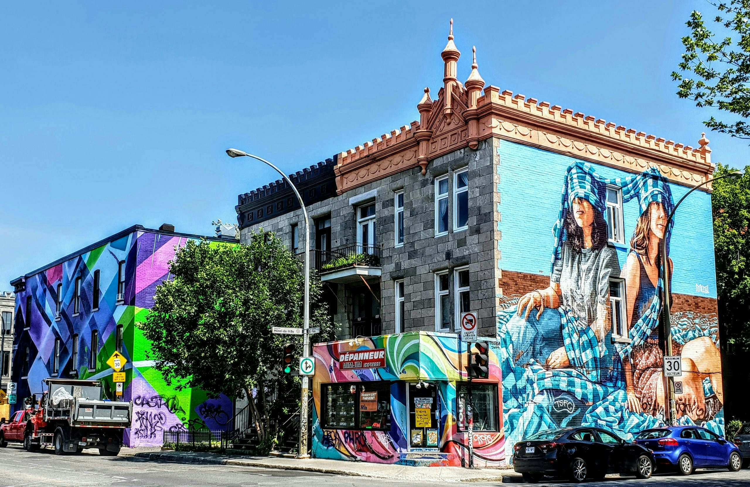 Colorful street mural decorating the side of a city building