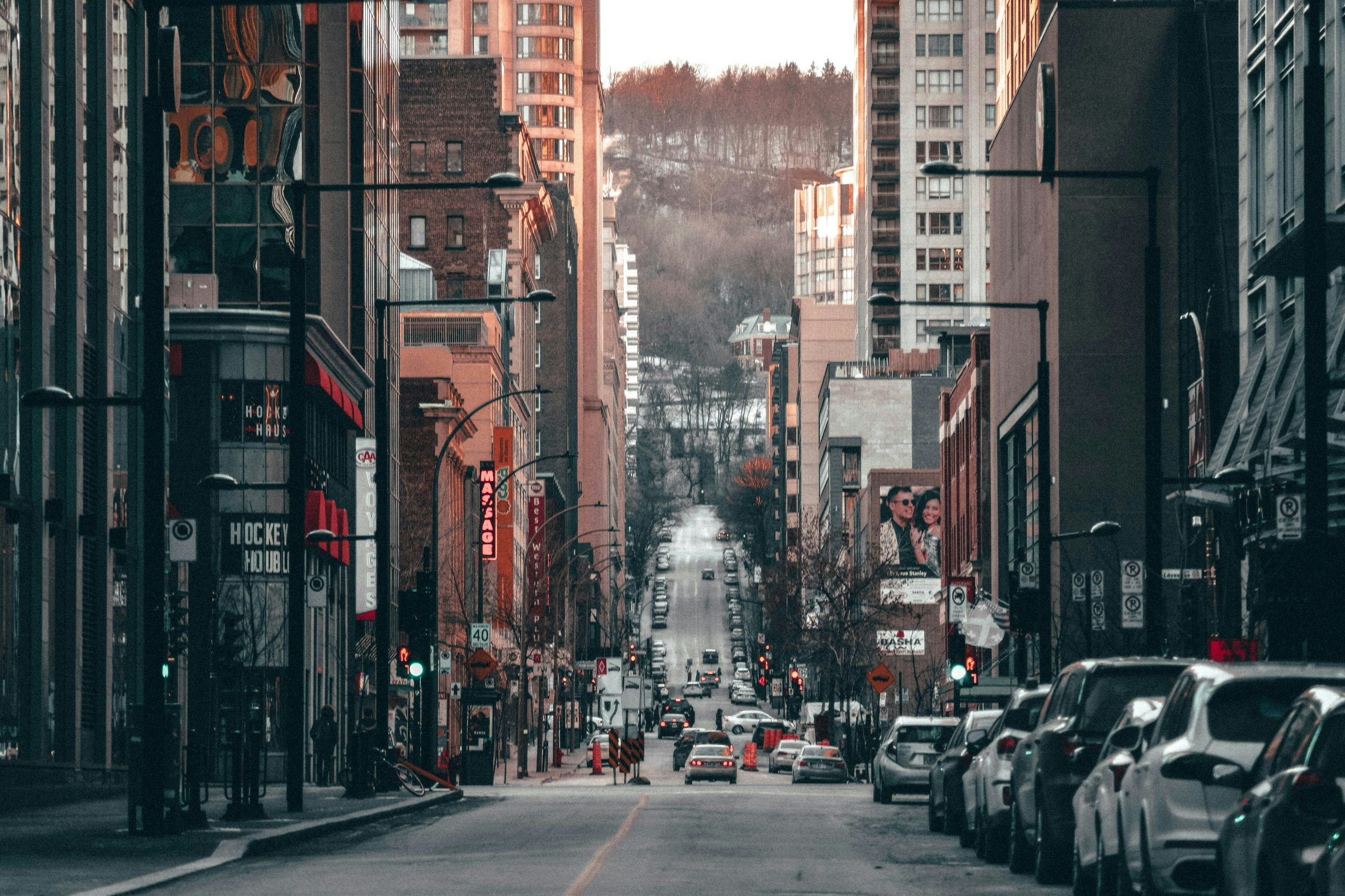 Busy downtown Montreal street with shops, cafés, and pedestrians