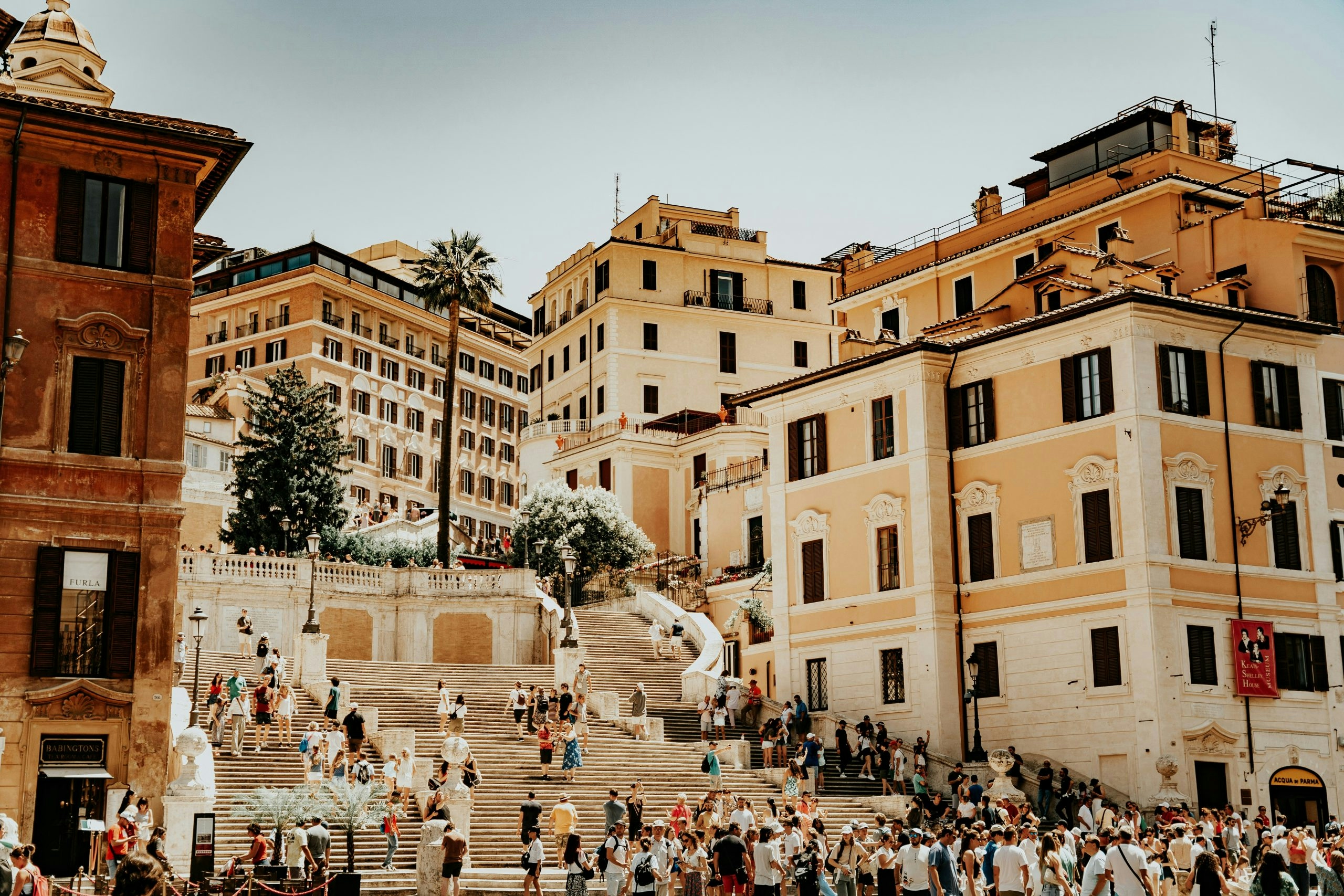 Crowds of people walking along a busy street in Rome, Italy