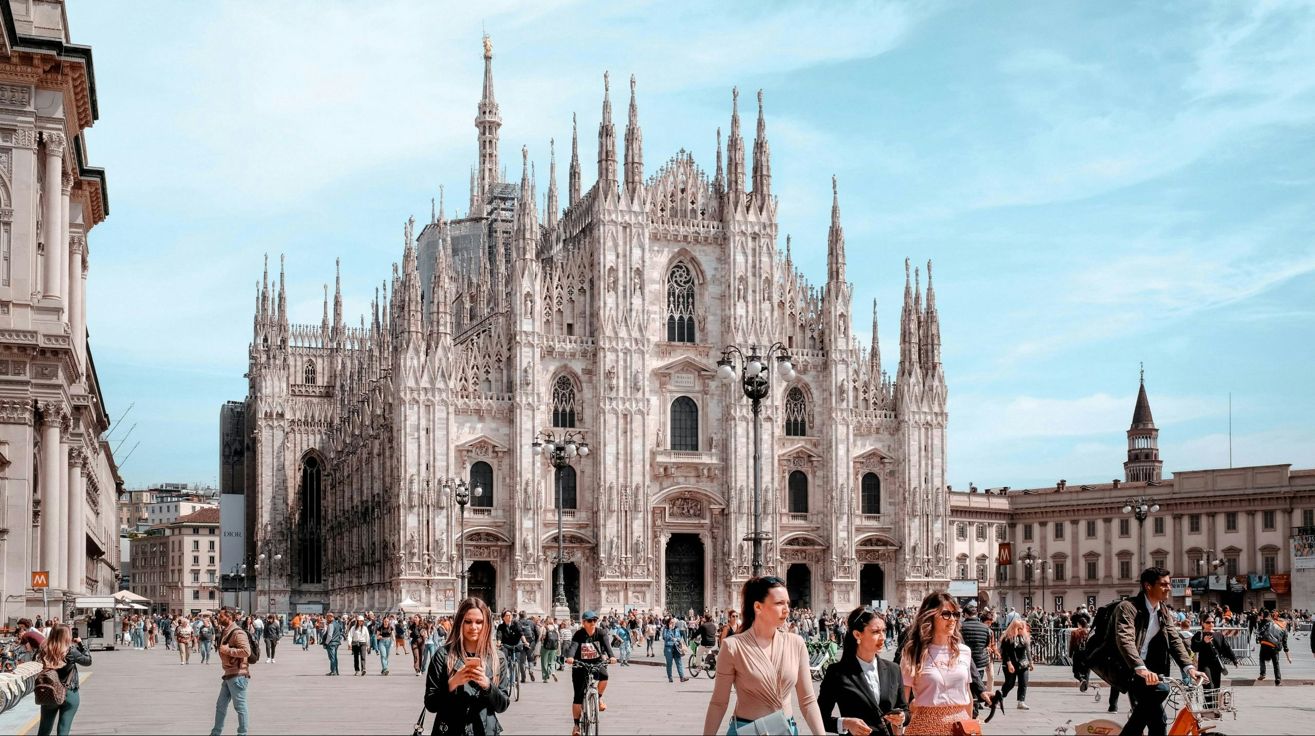 Historic Duomo di Milano surrounded by visitors in central Milan