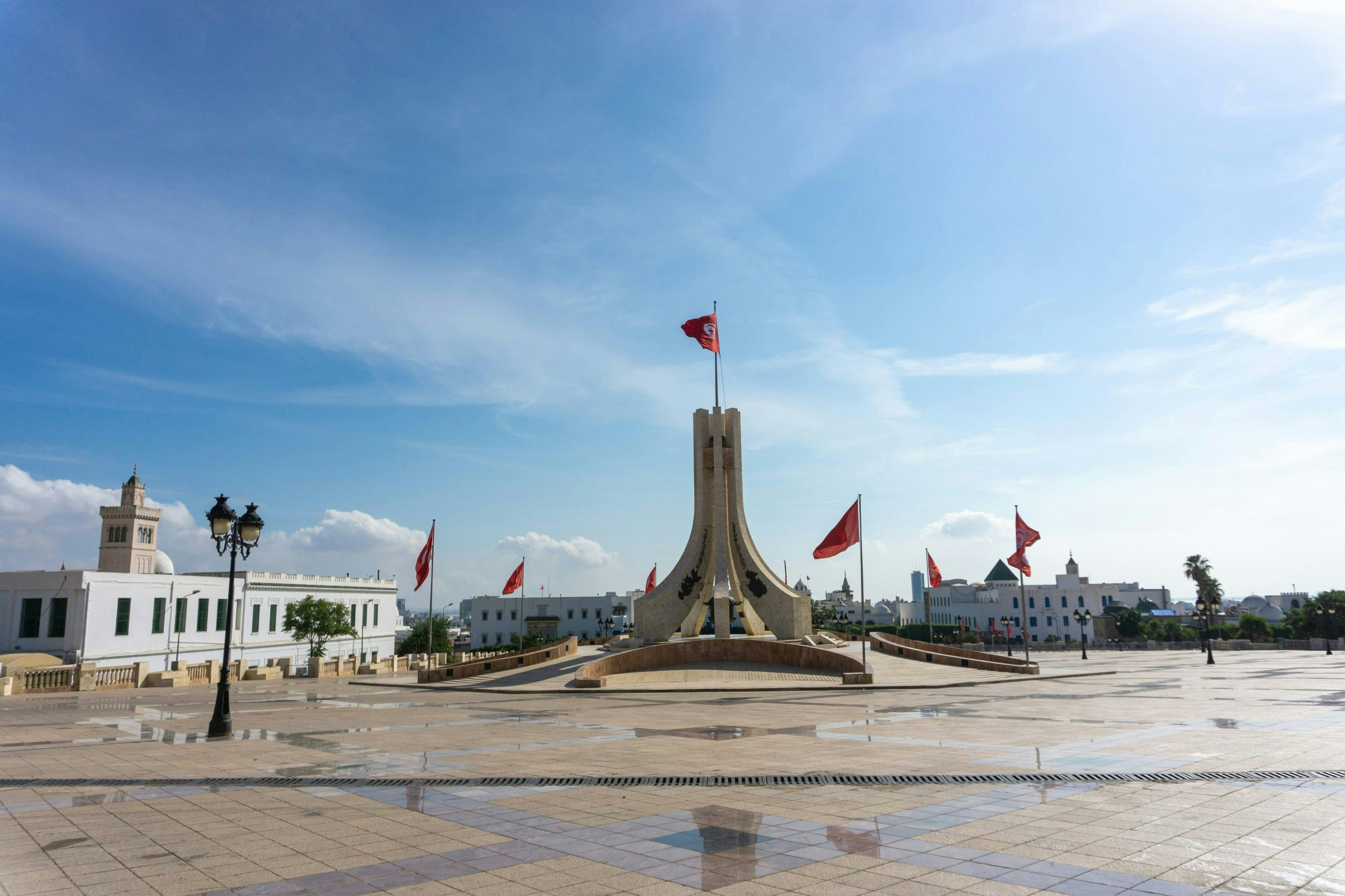 Scenic Tunisian plaza with flags and surrounding buildings