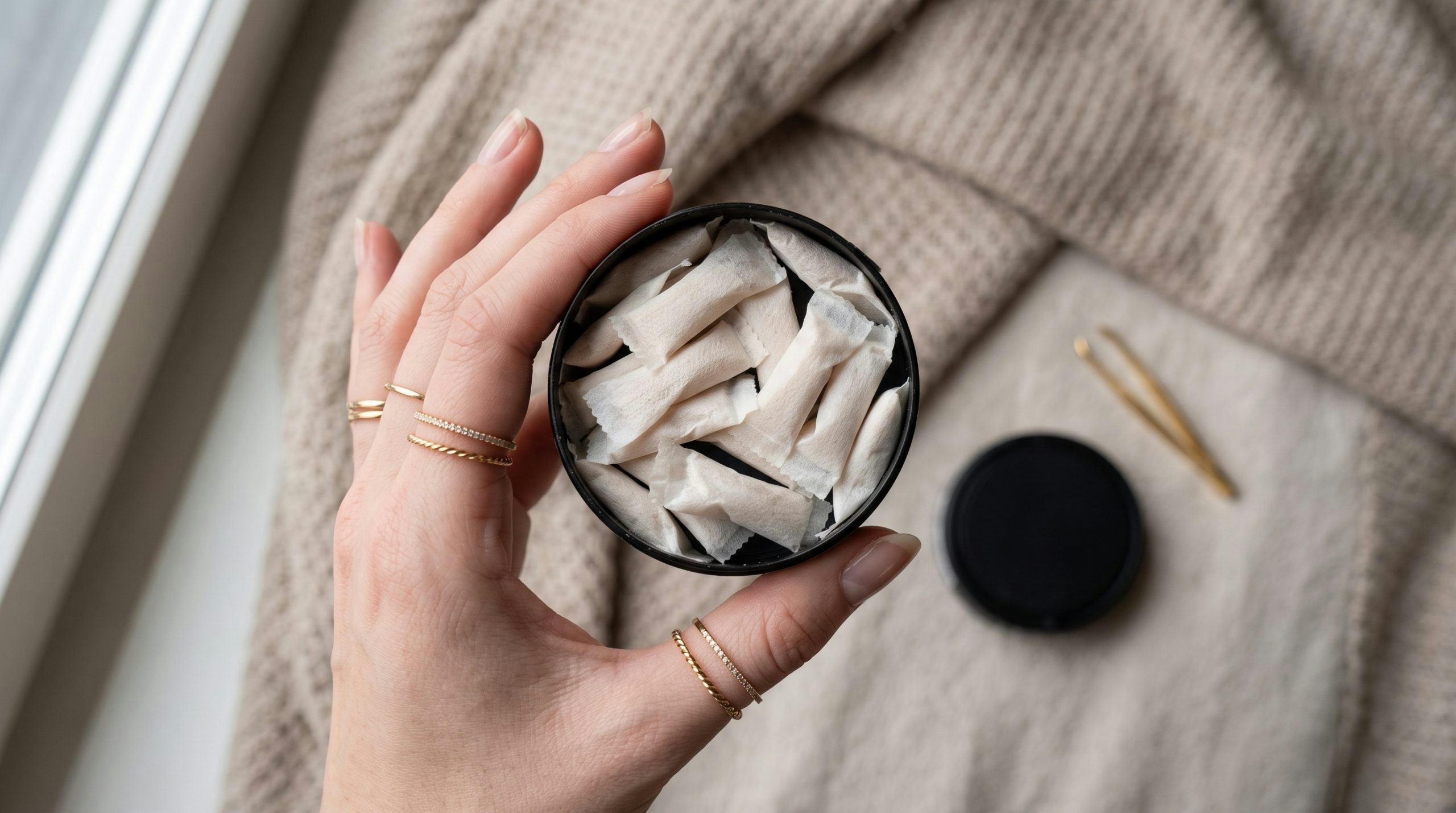 Close-up of nicotine pouches displayed in a hand