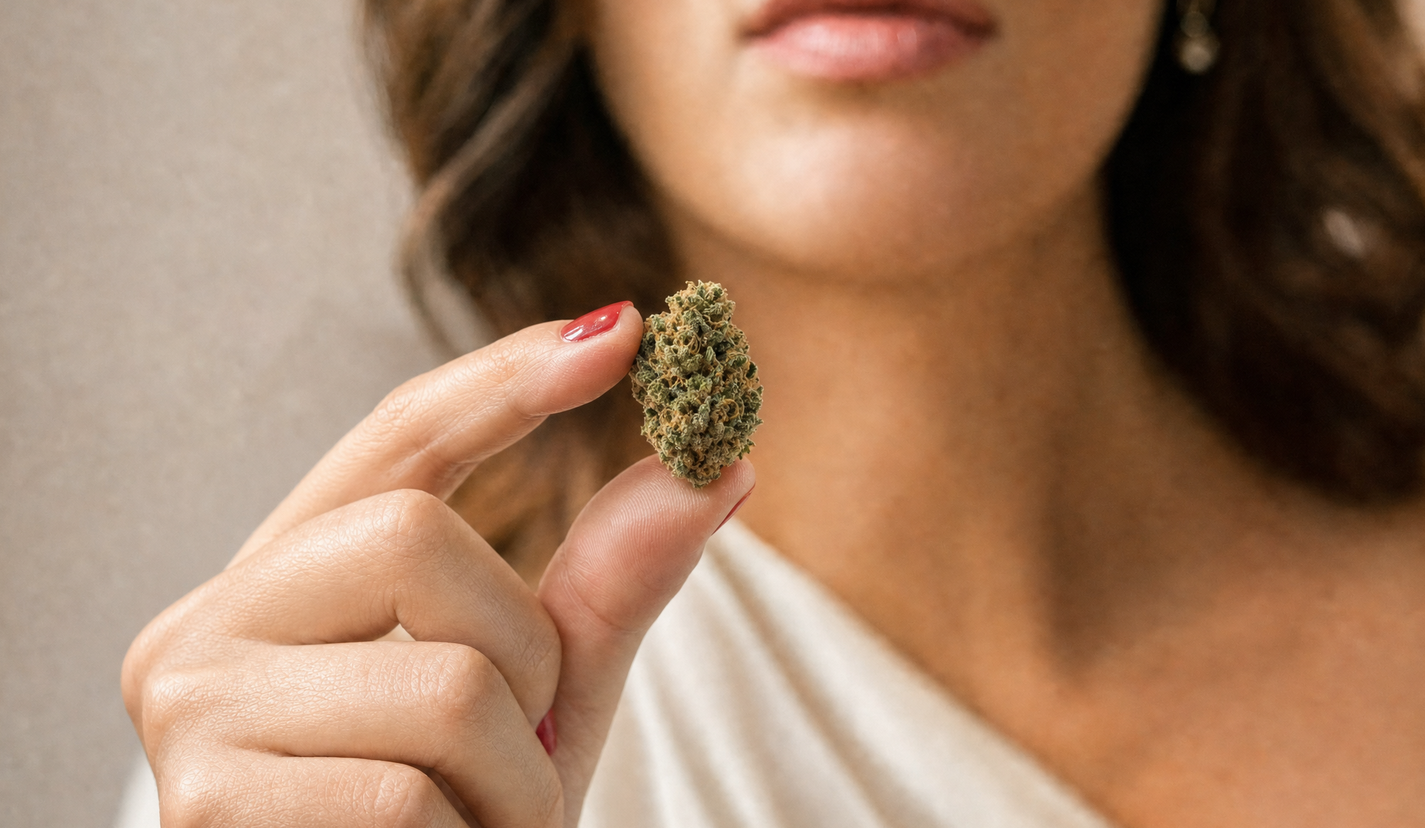 woman holding a cannabis bud