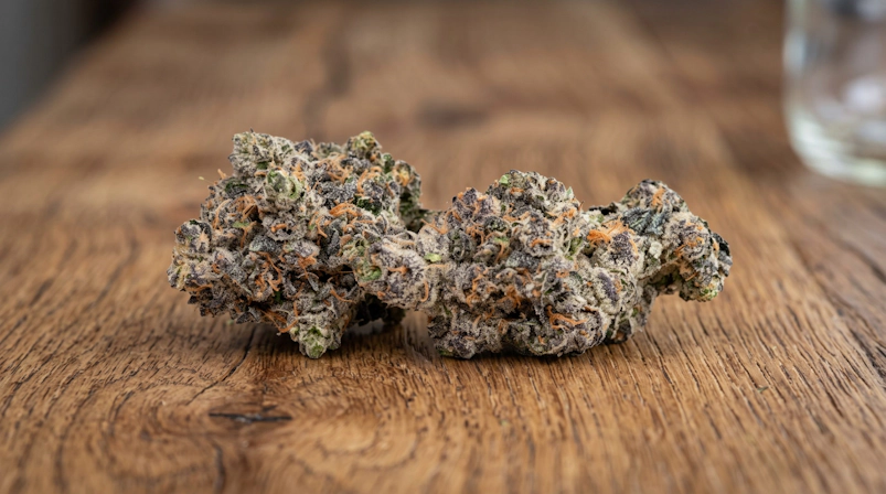 Close-up view of cannabis flower buds over a wooden table