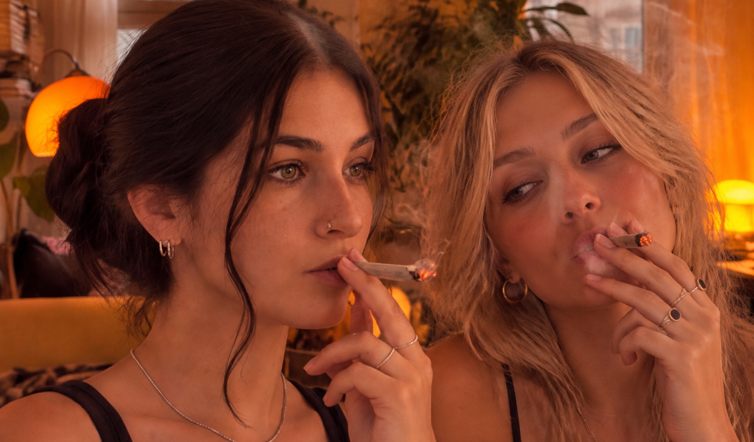 two women smoking a joint