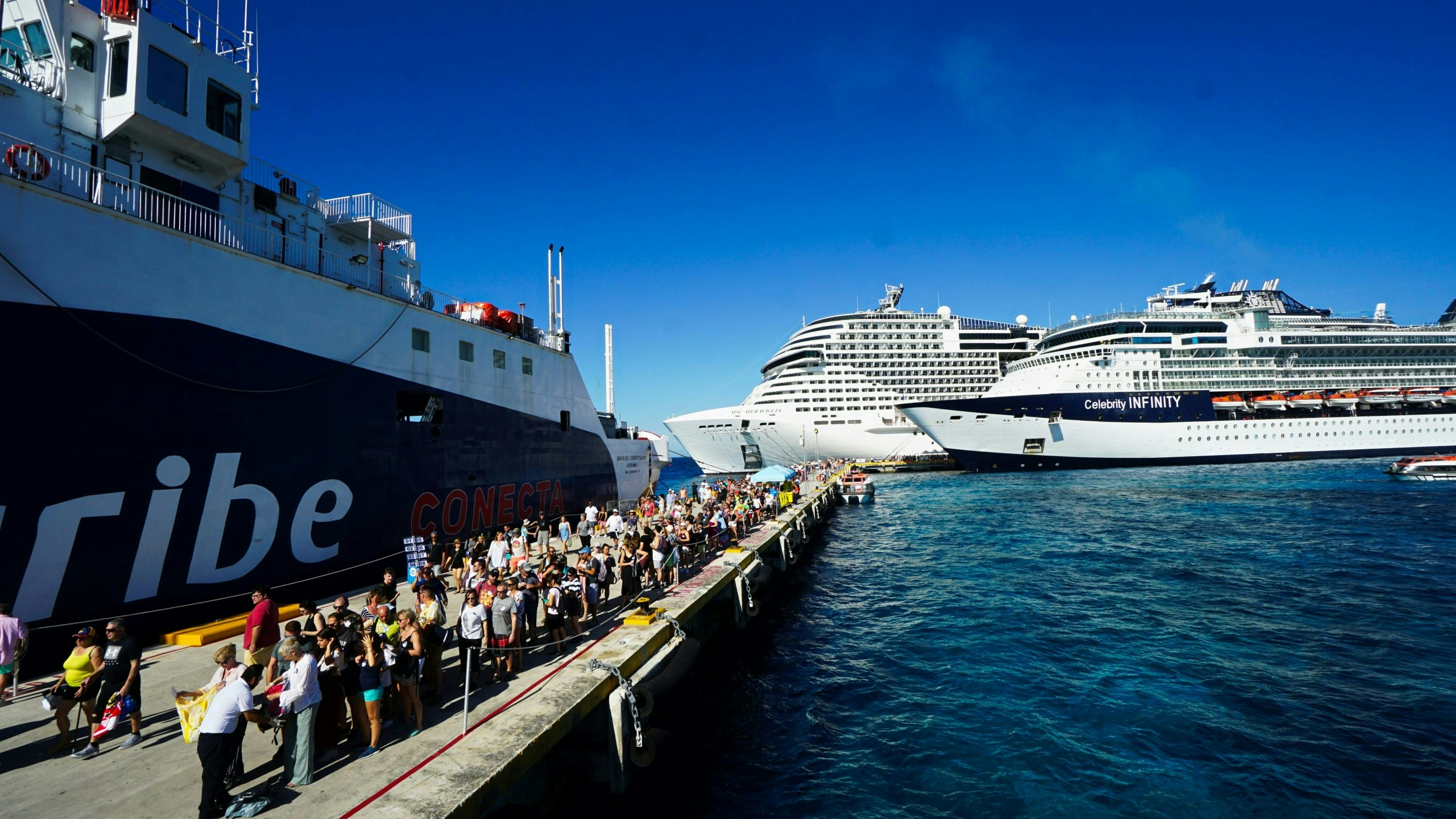 People standing in line to board a cruise ship