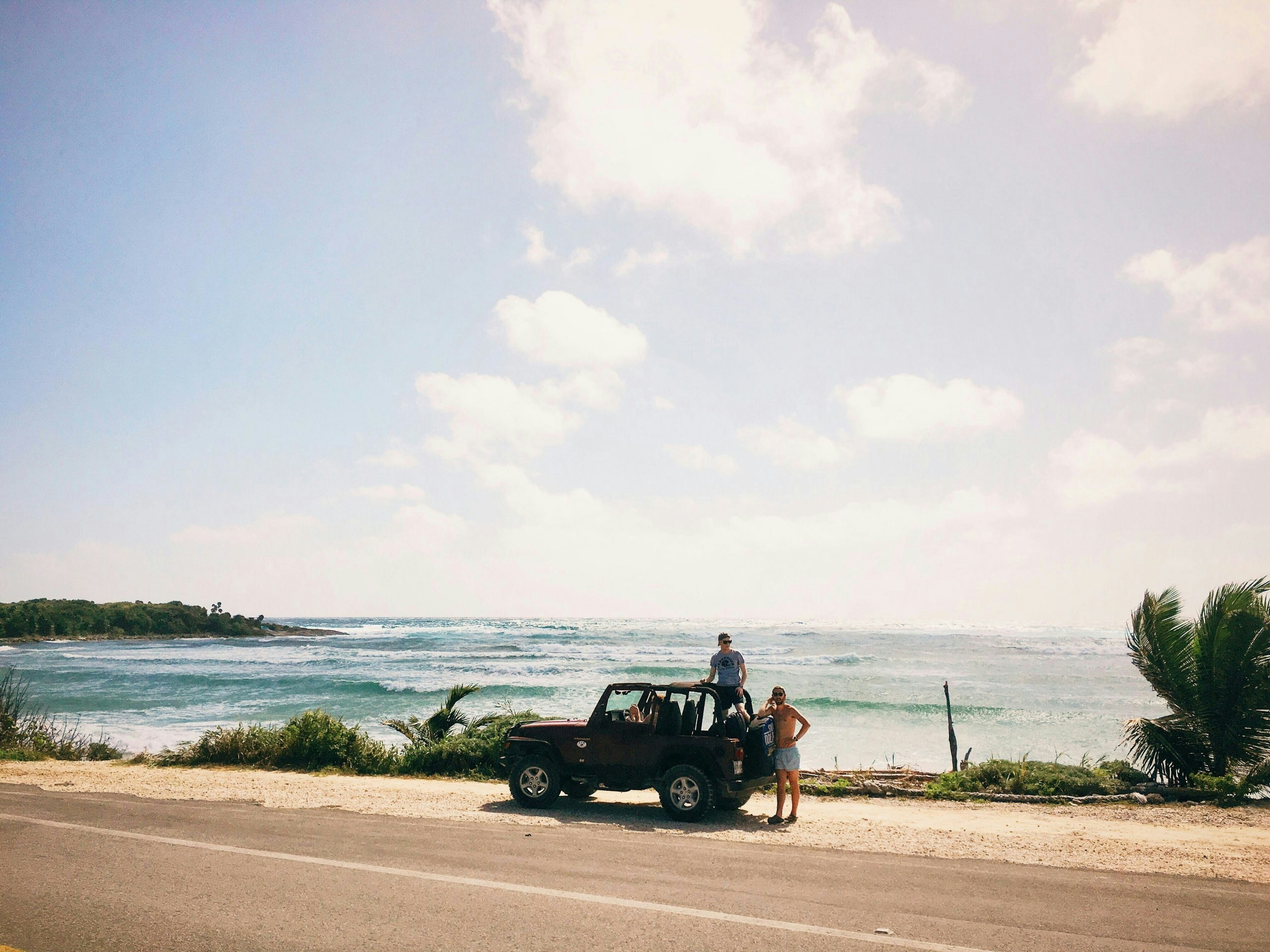 Car parked along the waterfront in Cozumel with the Caribbean Sea in the background
