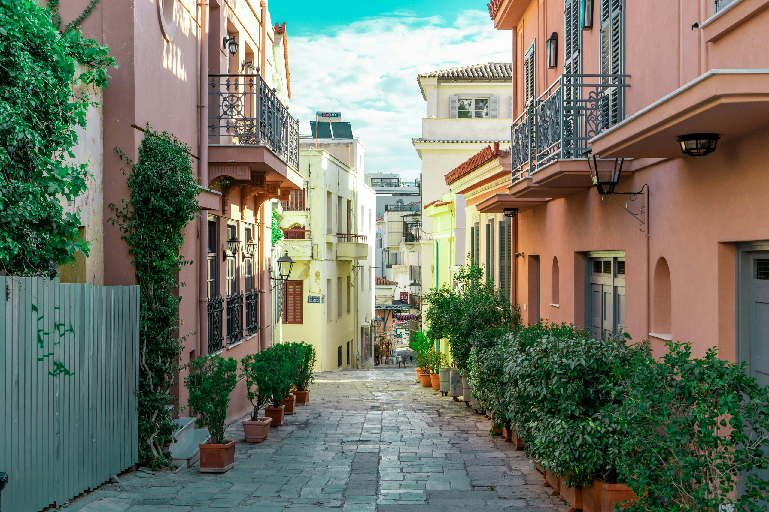 Traditional street in Athens, Greece, lined with historic buildings and local shops
