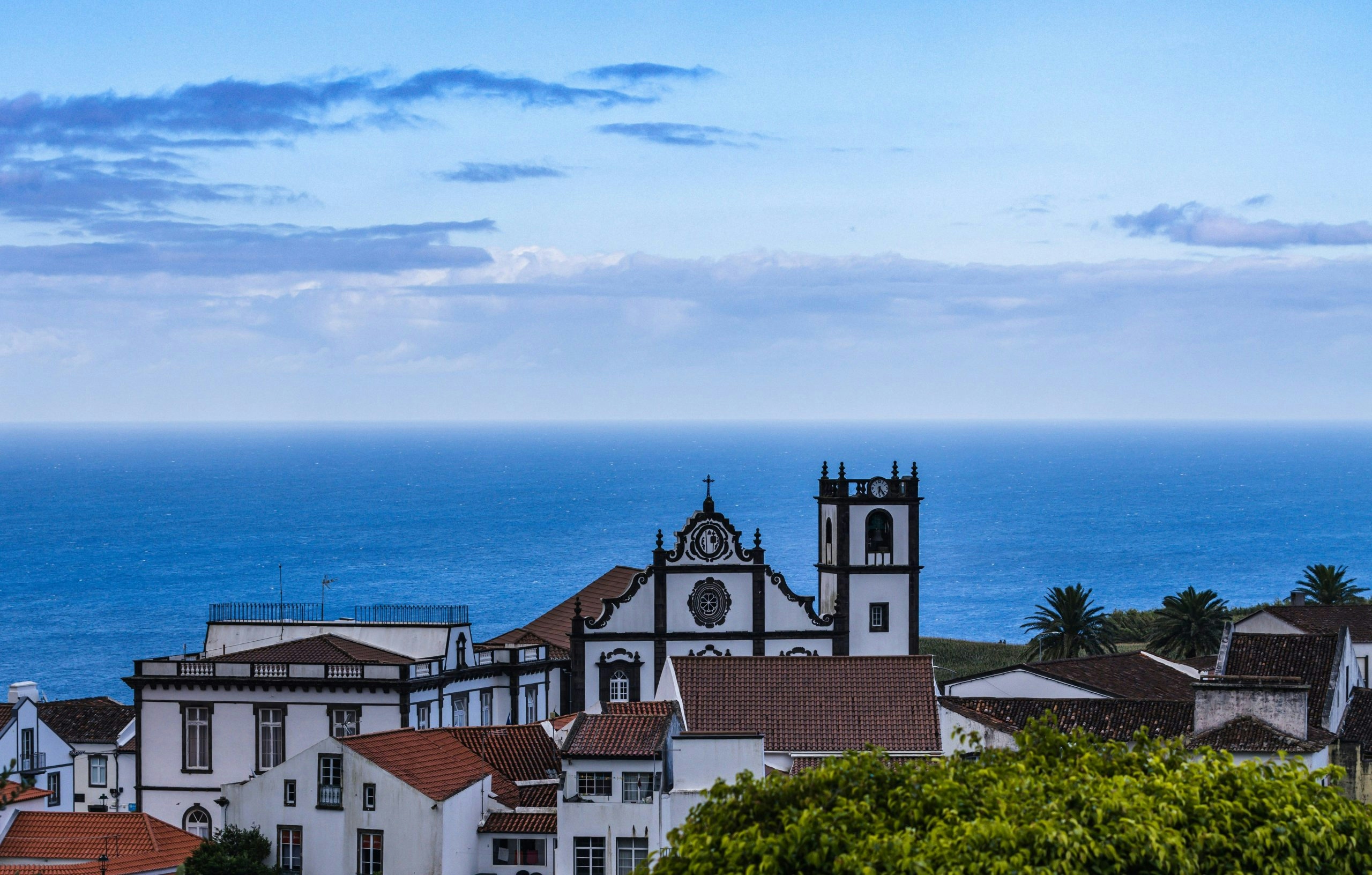 Panoramic view of the Azores featuring rolling green landscapes and the Atlantic Ocean