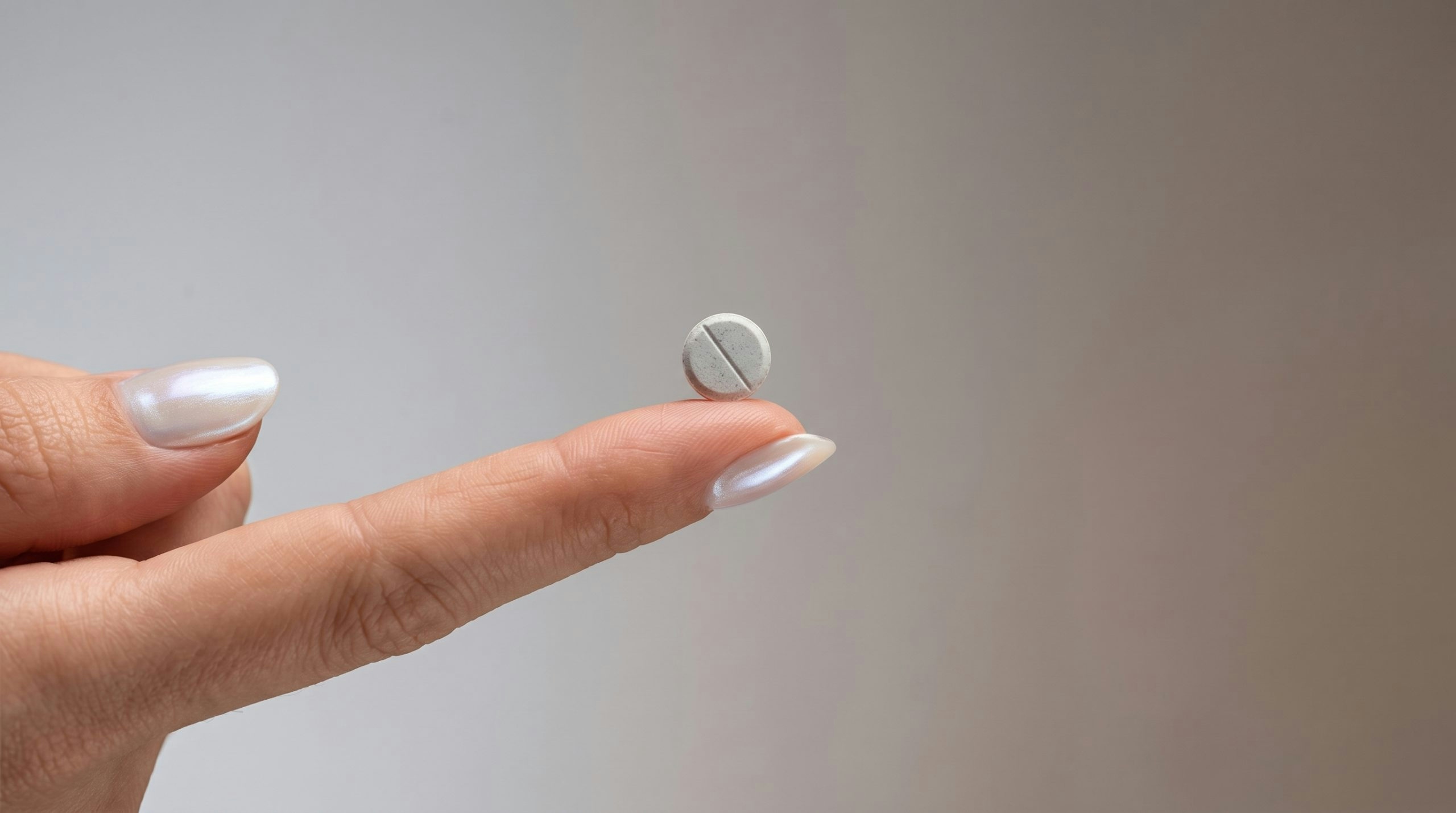 a tiny mint on top of an index finger