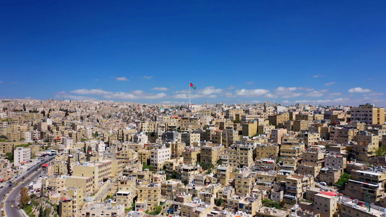 Flag of Jordan displayed against a clear sky