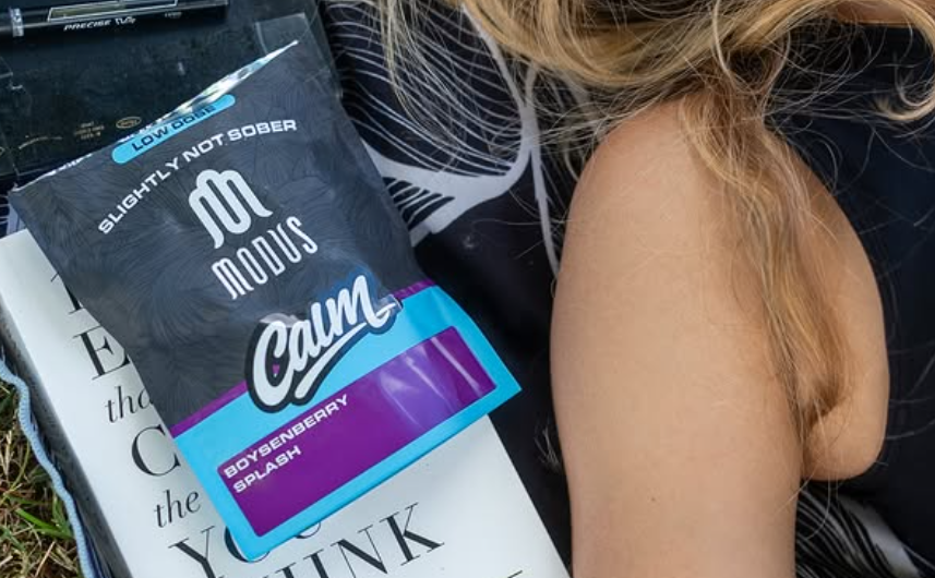 a package of sns gummies next to a woman lying down