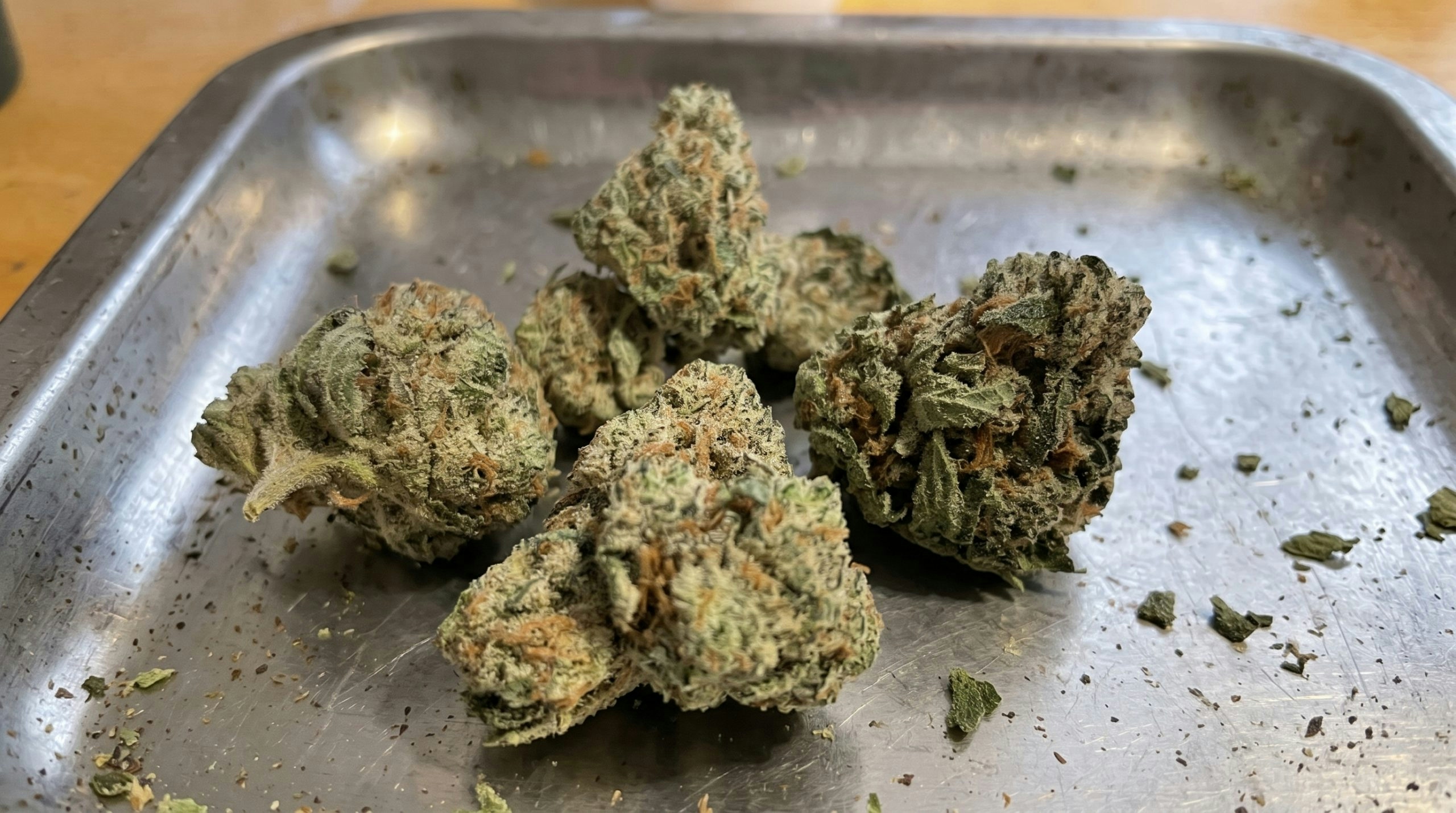 cannabis buds on top a silver tray