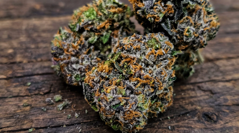 cannabis buds on a wooden table